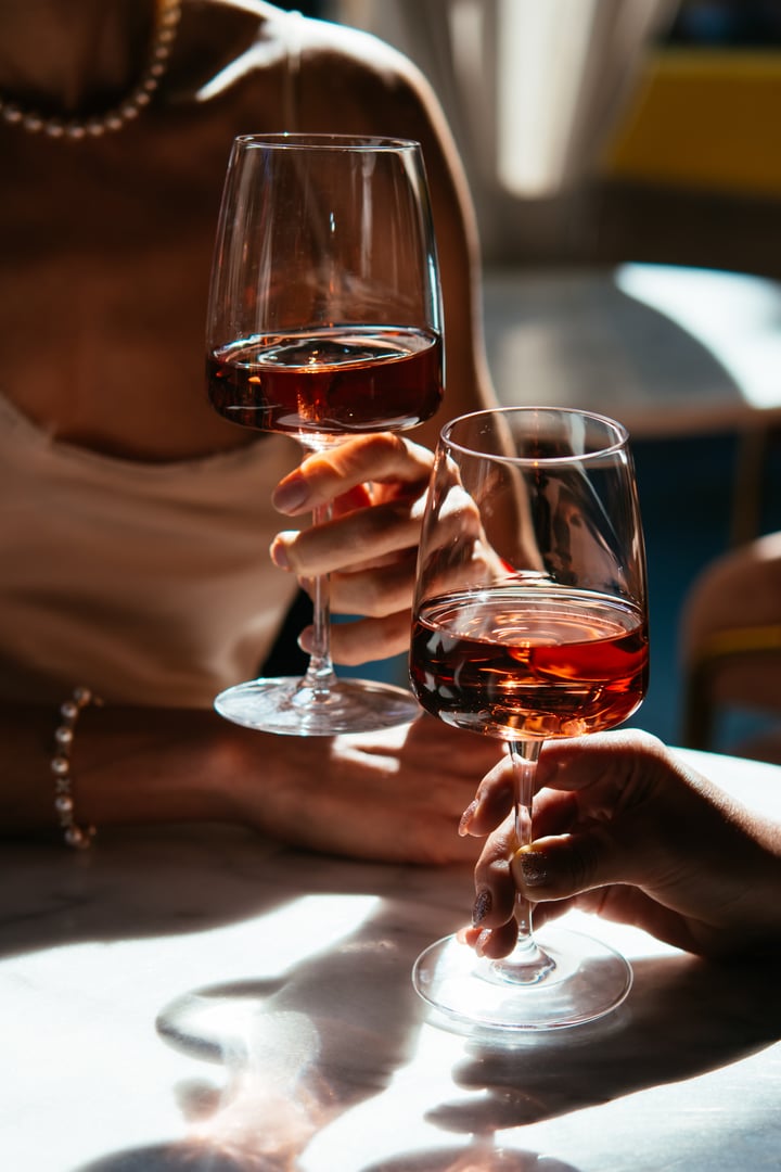 Glasses of rose wine seen during a friendly party or a celebration in a restaurant of a bar.