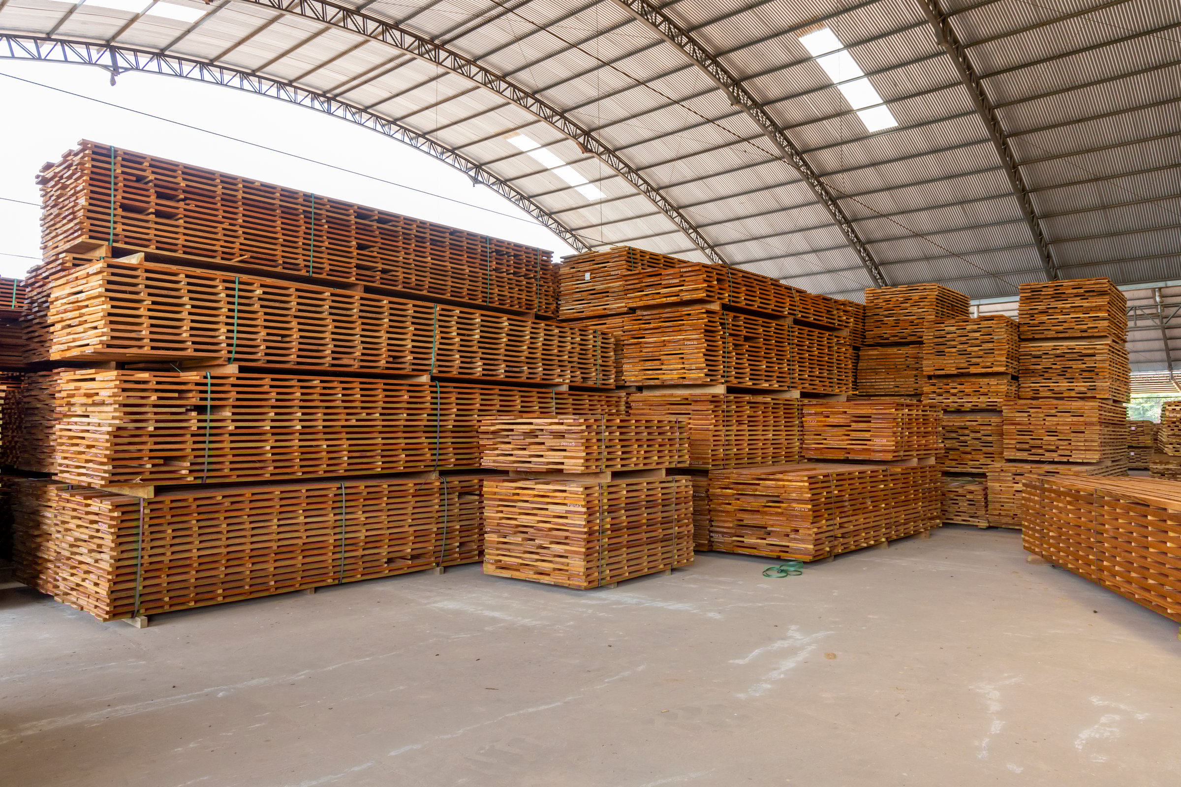 Stacked sawn timber stored inside a sawmill warehouse in the brazilian Amazon region