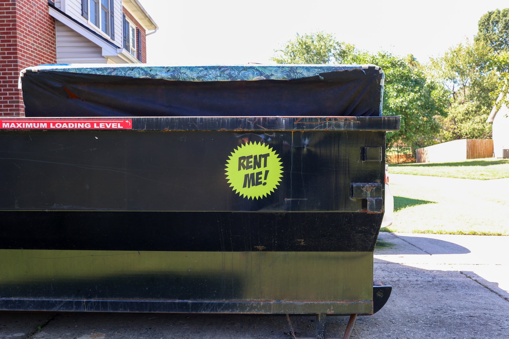 A rented dumpster in a residential driveway