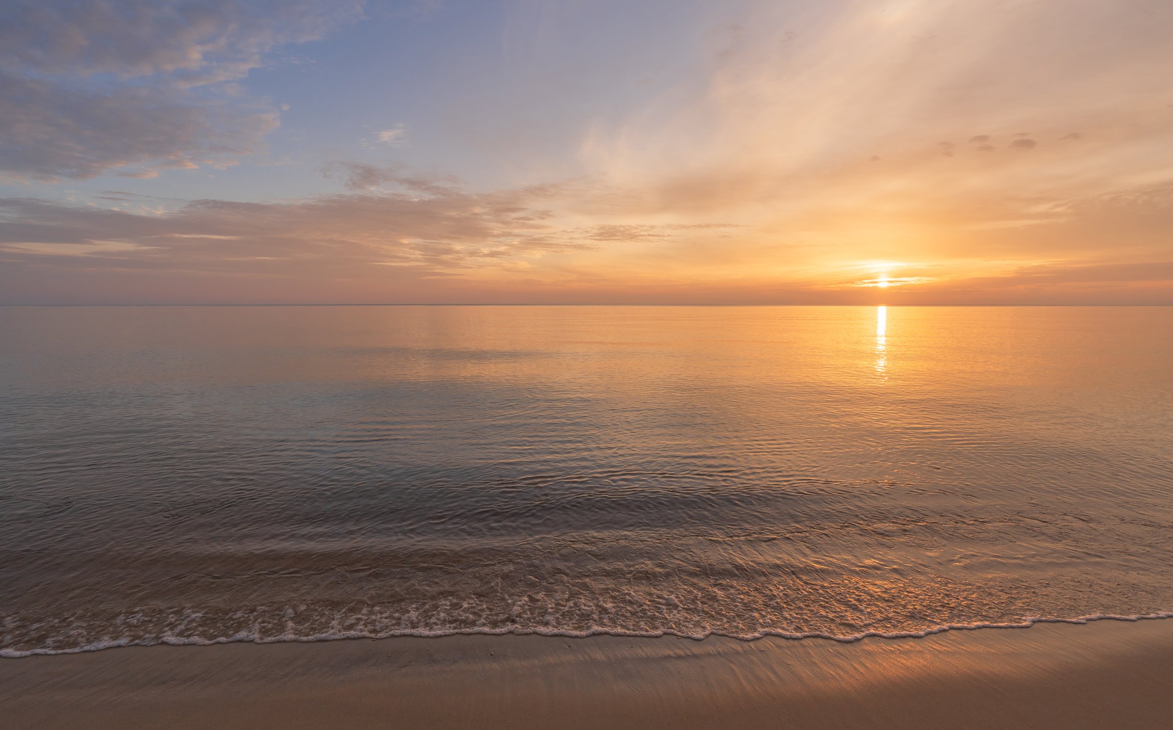 Sunrise sky clouds over sea water background in morning with orange, yellow sun light, Horizon sea ocean sunset sky landscape nature backgrounds and gold sun down in golden hour summer season, Dusk sky