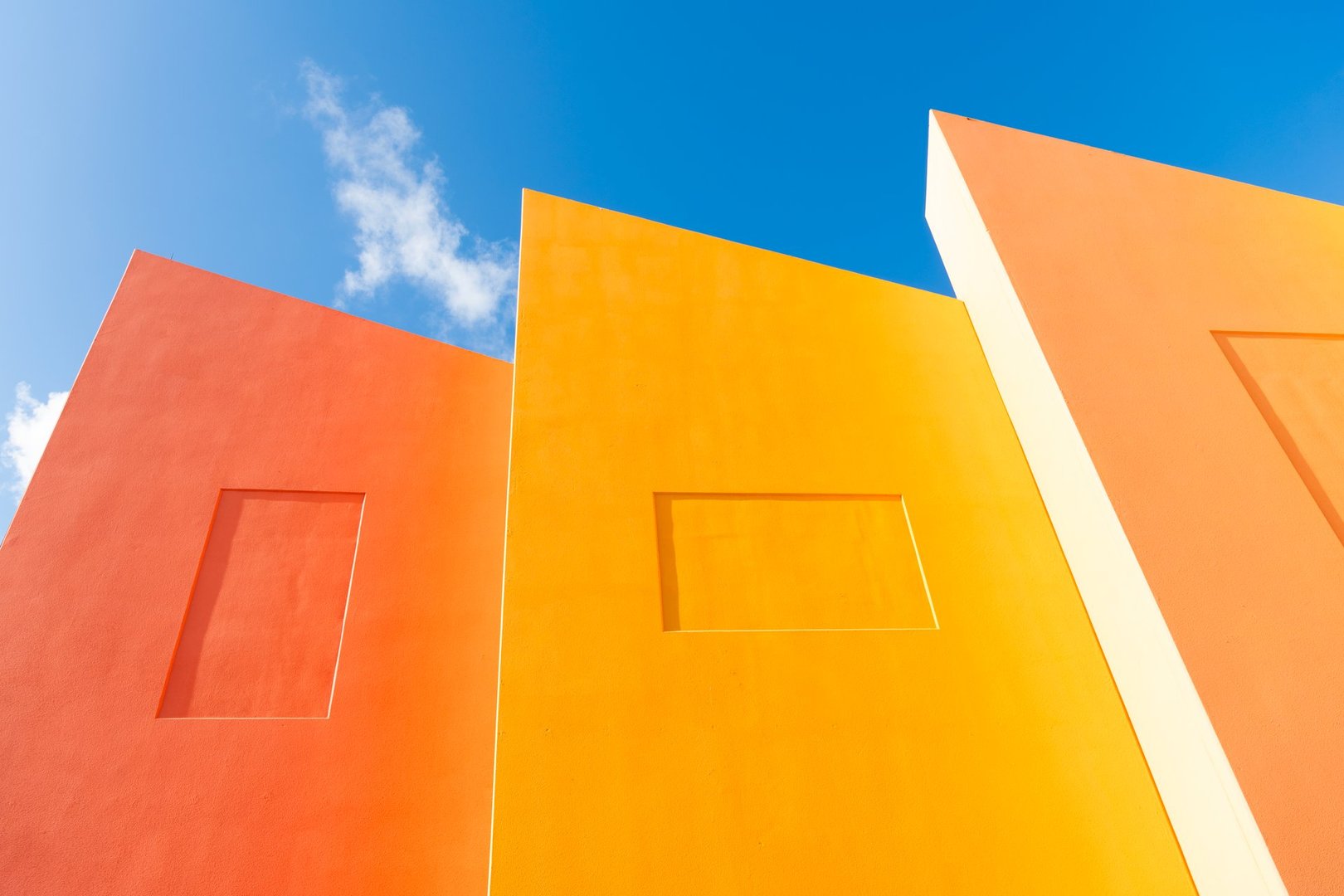 Geometric shape bright color. Modern building architecture against blue sky. Architectural geometrical detail.