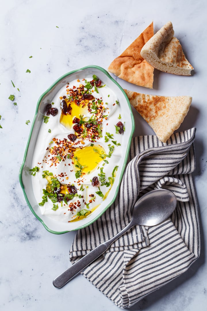 Whipped ricotta dip with chili, oil and cilantro, top view.