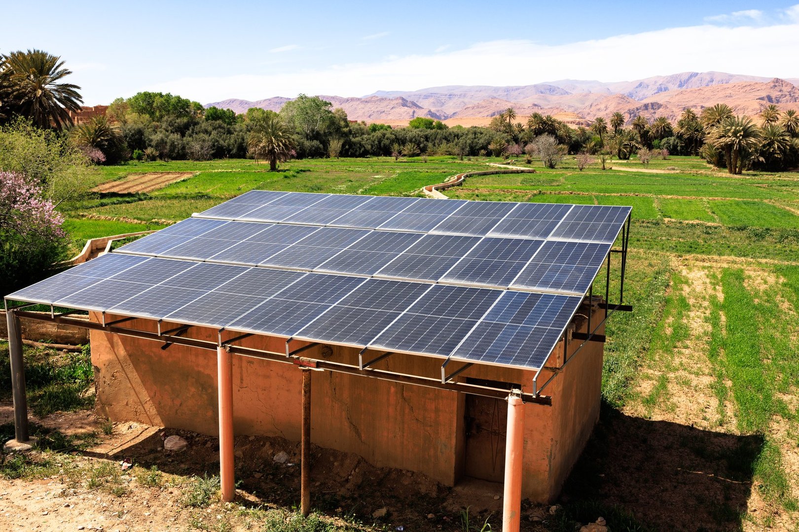 Solar panels powering a building in a lush oasis, promoting sustainable practices in Tinghir, Morocco
