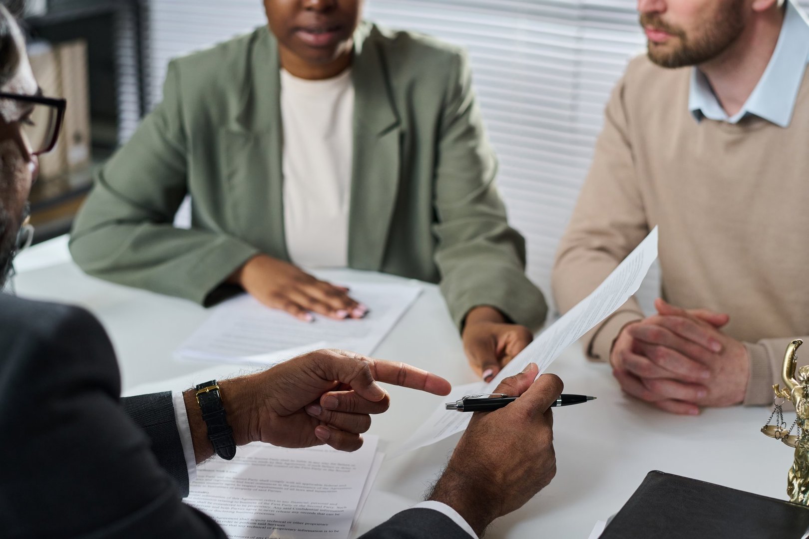 Professional African American woman notary signing documents with client