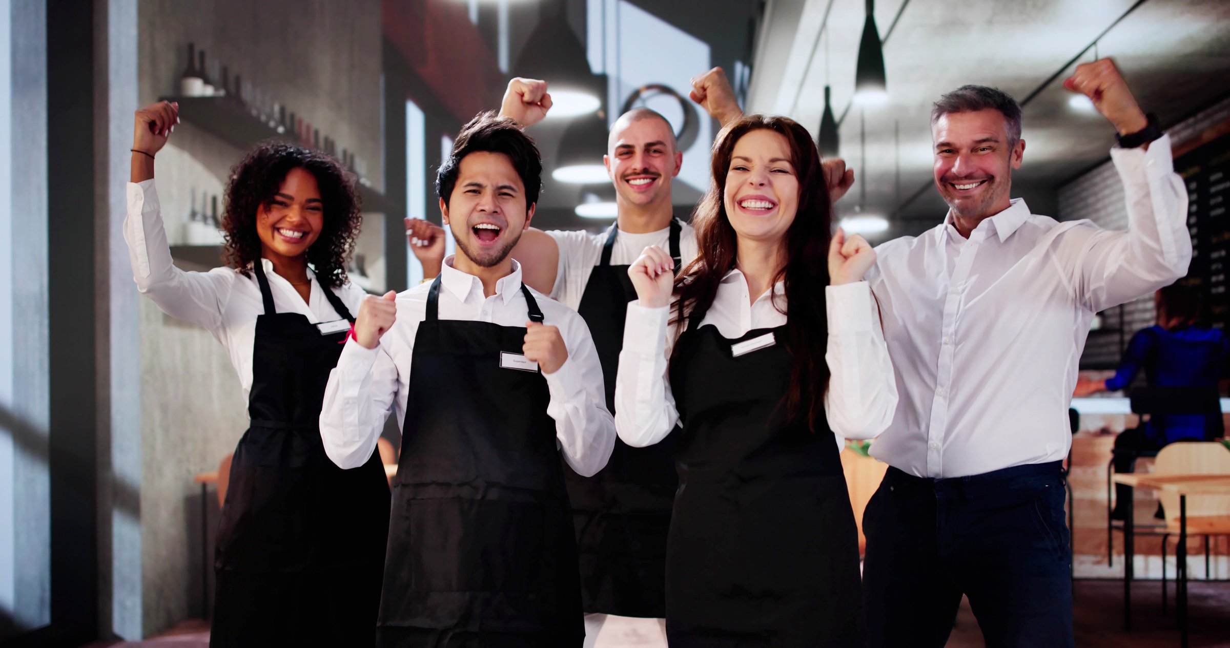 Happy Coffee Shop Employees In Shop. Group Success Celebration