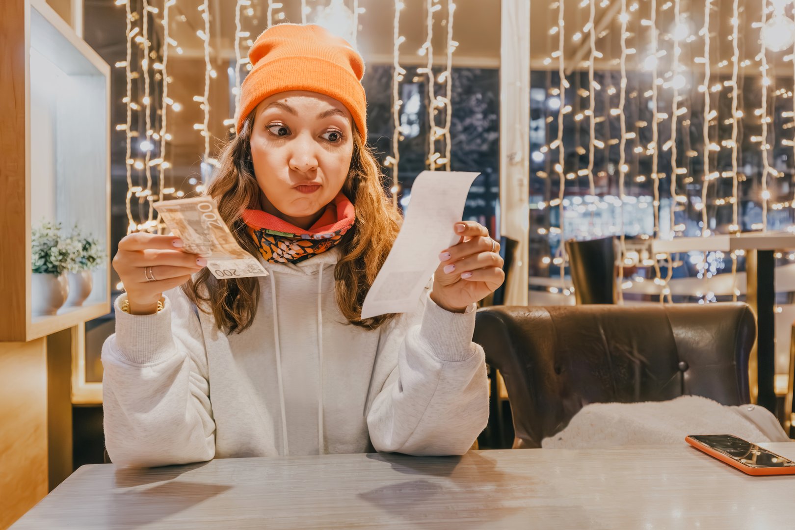 Surprised by the lunch bill, the bankrupt individual experiences panic at the realization of their financial situation, grappling with the repercussions of overspending.