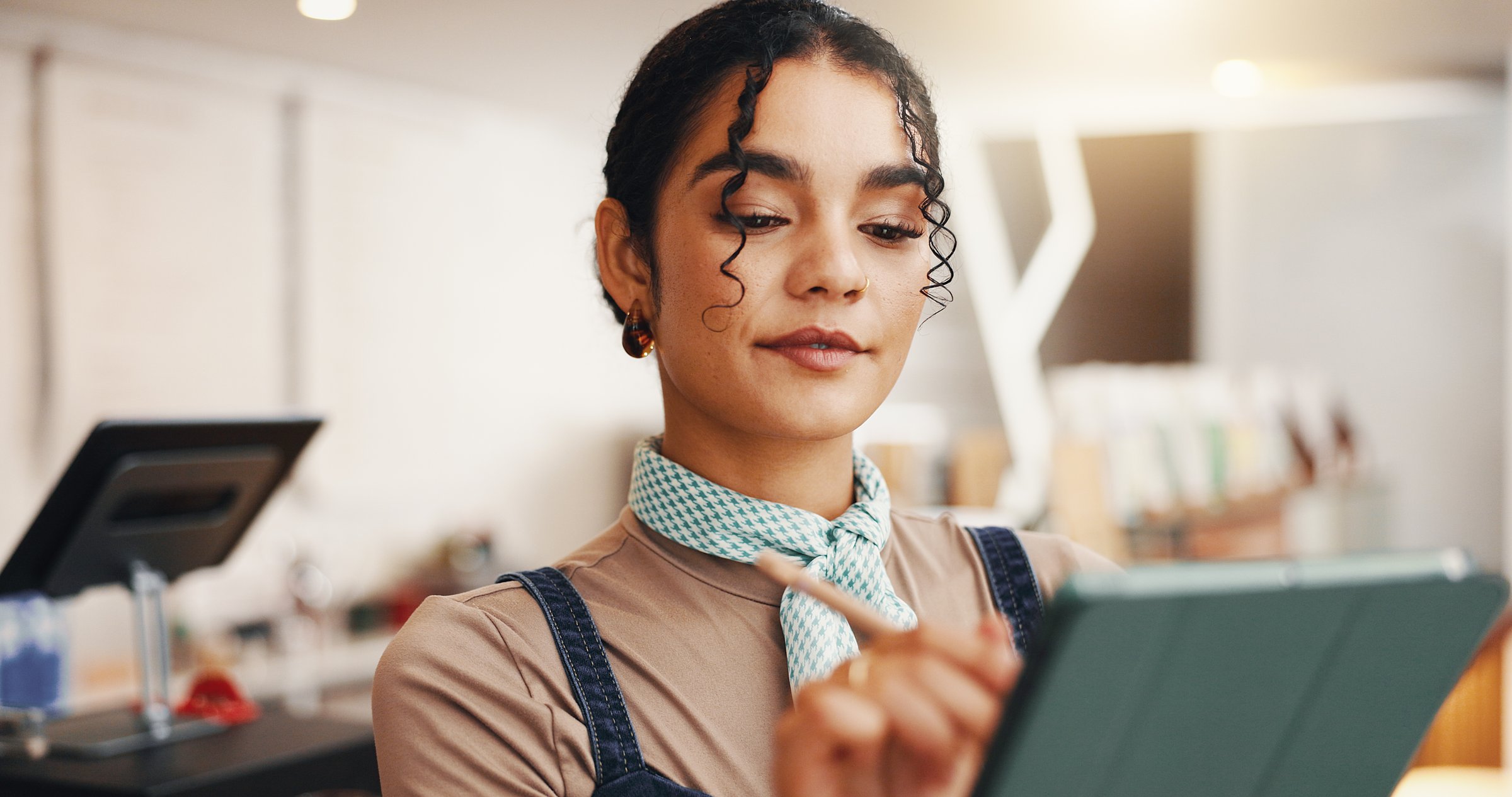 Employee, stylus and woman in coffee shop, tablet and check inventory with ecommerce. Person, restaurant host and business owner in cafe, tech or online order with digital app for menu or hospitality