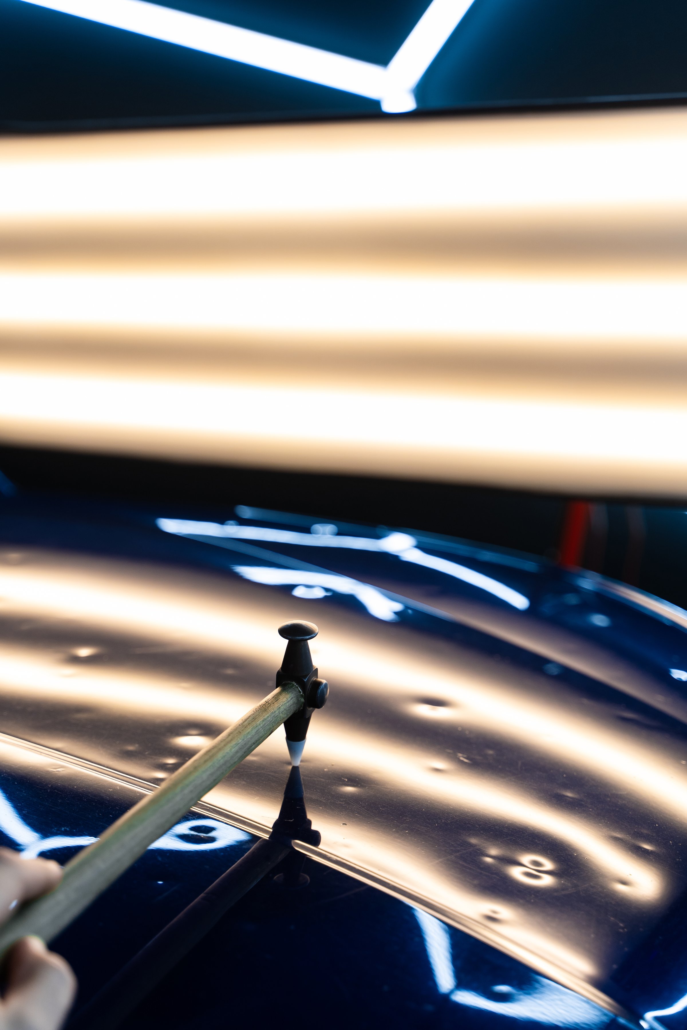 PDR technician uses a knockdown tool and hammer combo to correct hail dents. Focused strikes realign metal without harming paint. Controlled taps with a knockdown tool reshape metal warped by hail