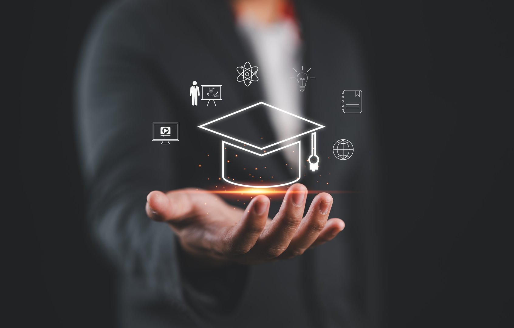 Graduate education certificate concept. man hands showing graduation hat, Internet online education course degree, study knowledge to creative thinking idea and problem solving solution