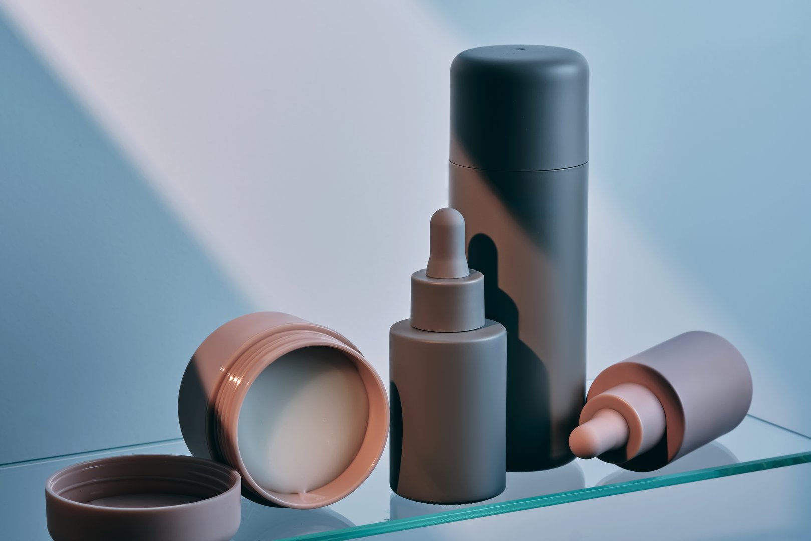 A composition of cosmetic care products on a glass shelf. High quality photo.
