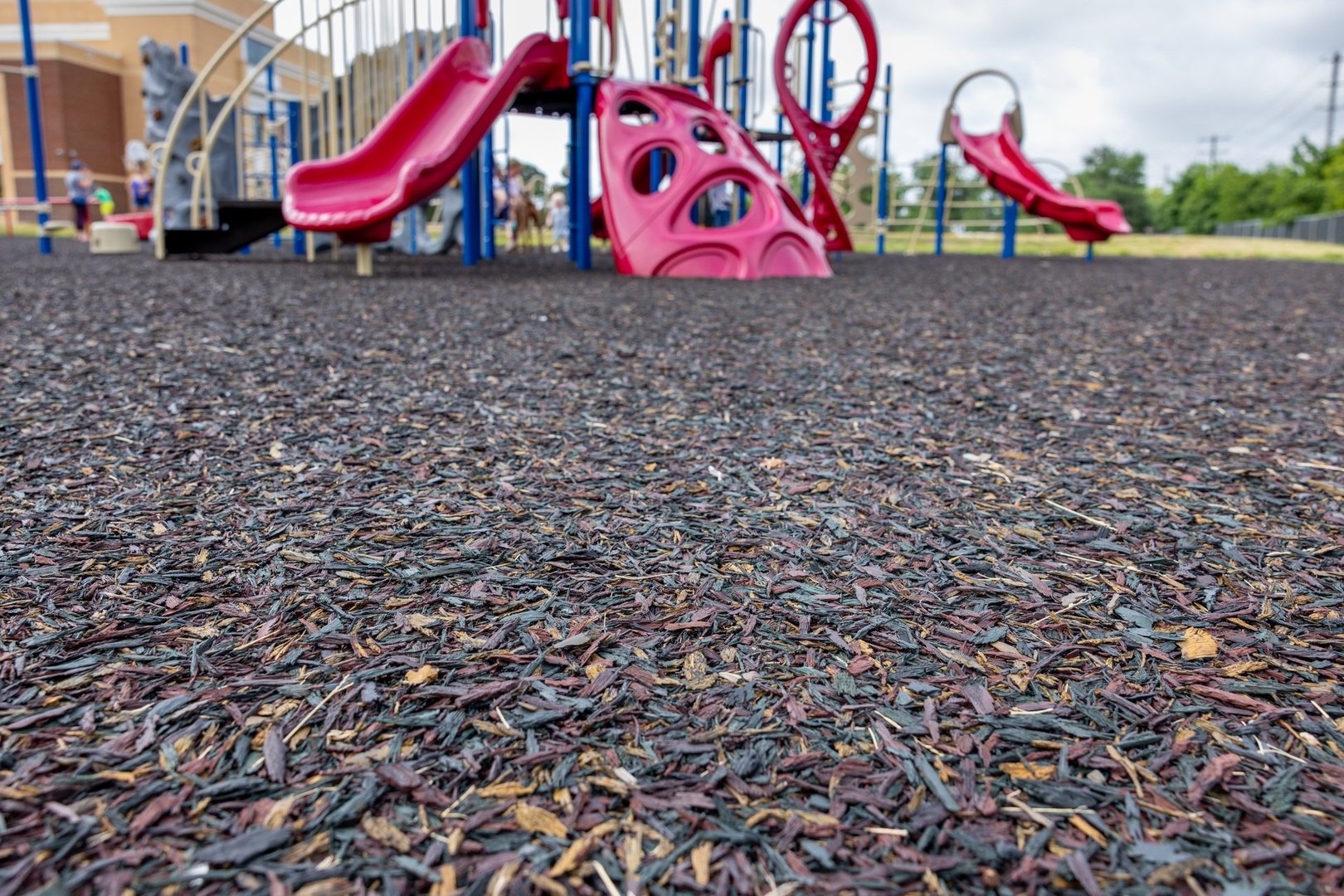 Recycled rubber material used on a playground to provide safer, non-slip, shock absorbing surface