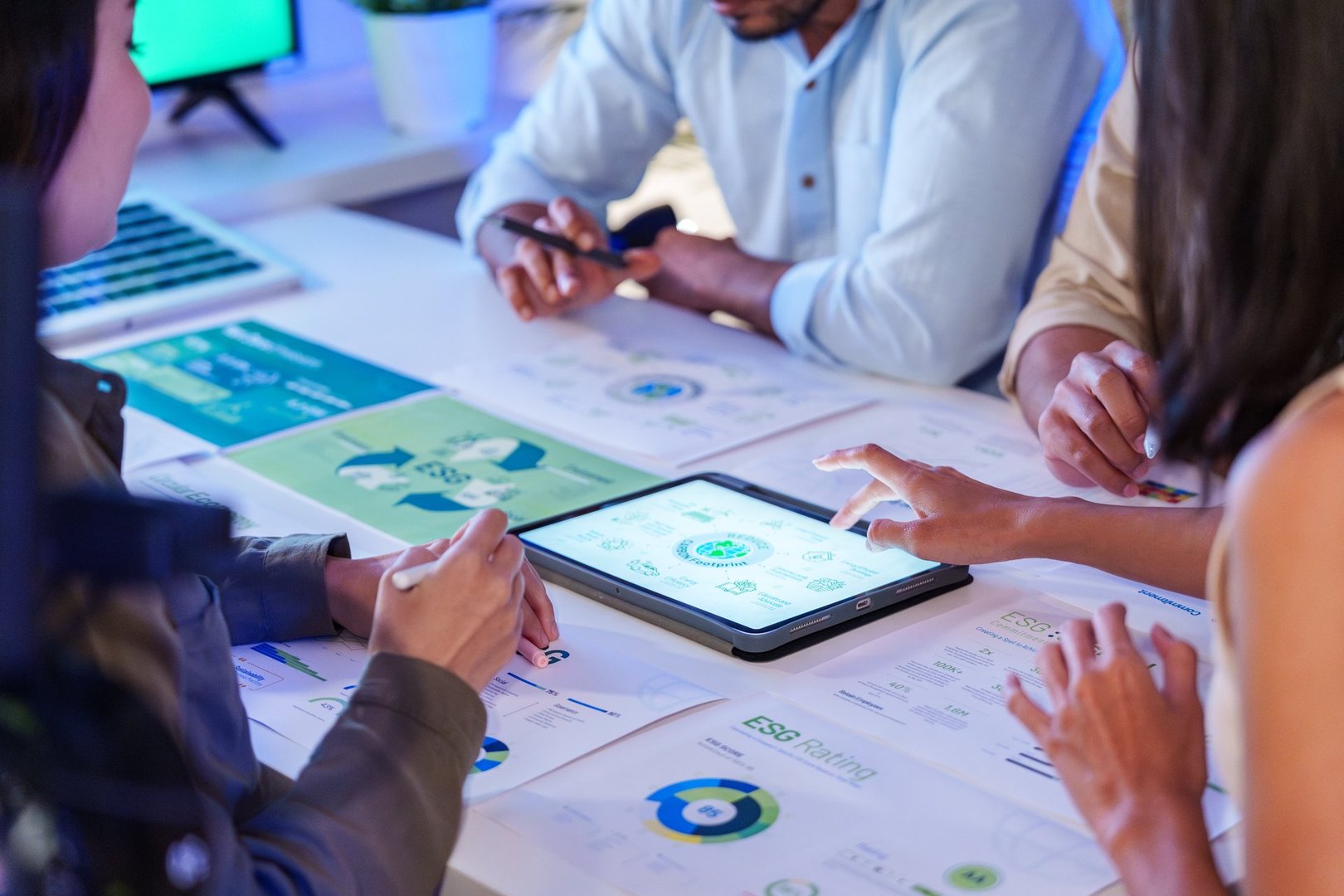 diversity team discussion about esg and eco friendly system planning in sustainable green office at night