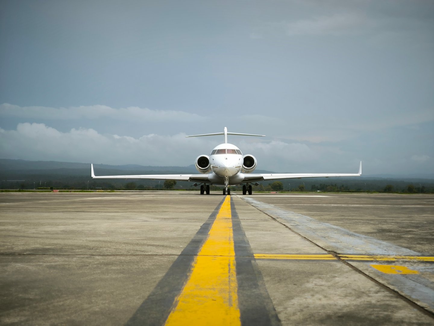The Close view of Private Jet Aircraft Parking on The Airport parking stand, it appears in a black and yellow sign line on the ground, this Aircraft just Landed from Departure Airport and preparing to the next destination