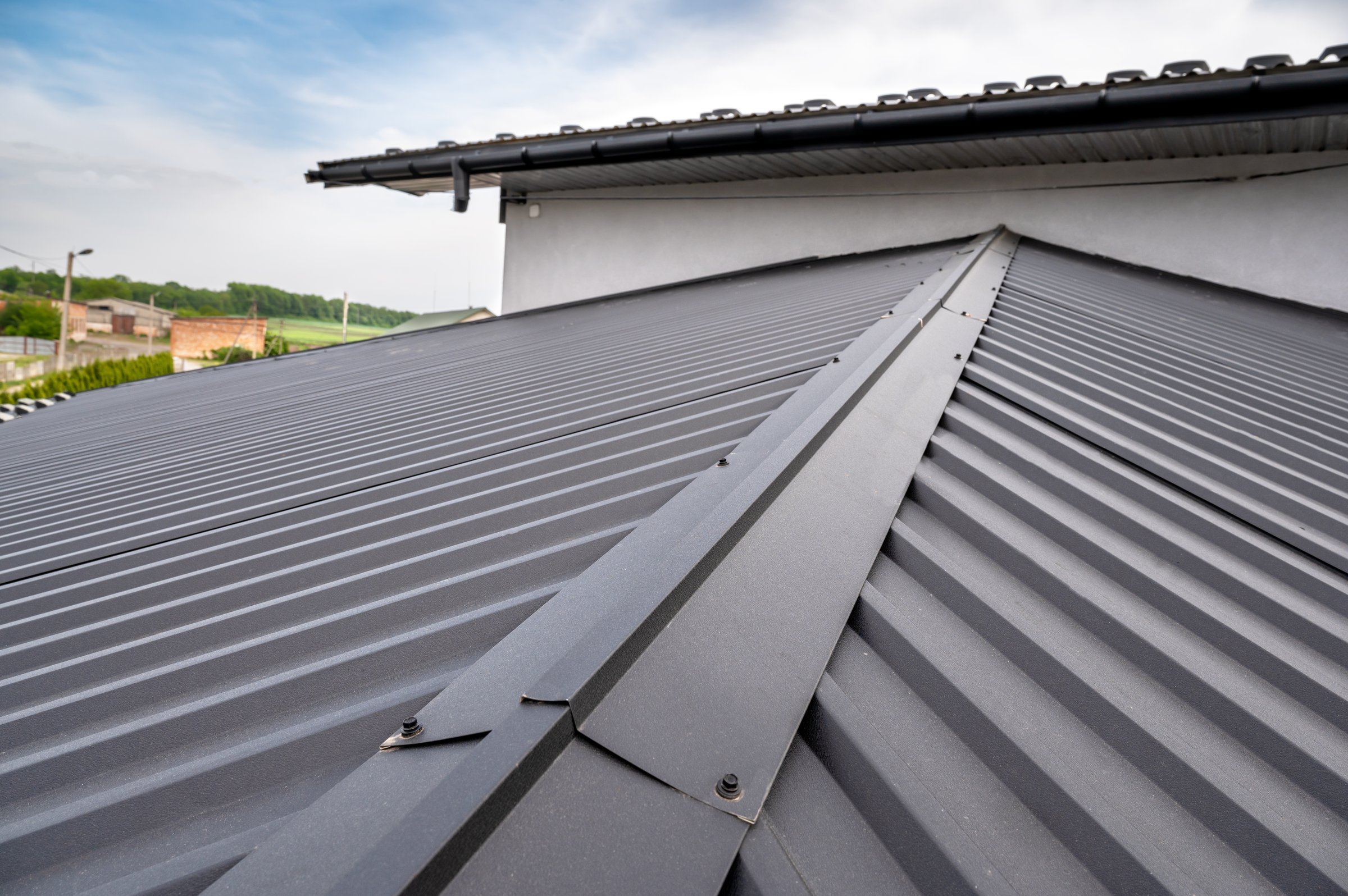 Gutter system for a metal roof. Holder gutter drainage system on the roof.