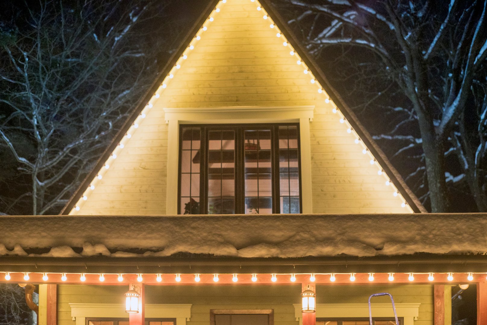 facade of a country house decorated with electric lights, night scene