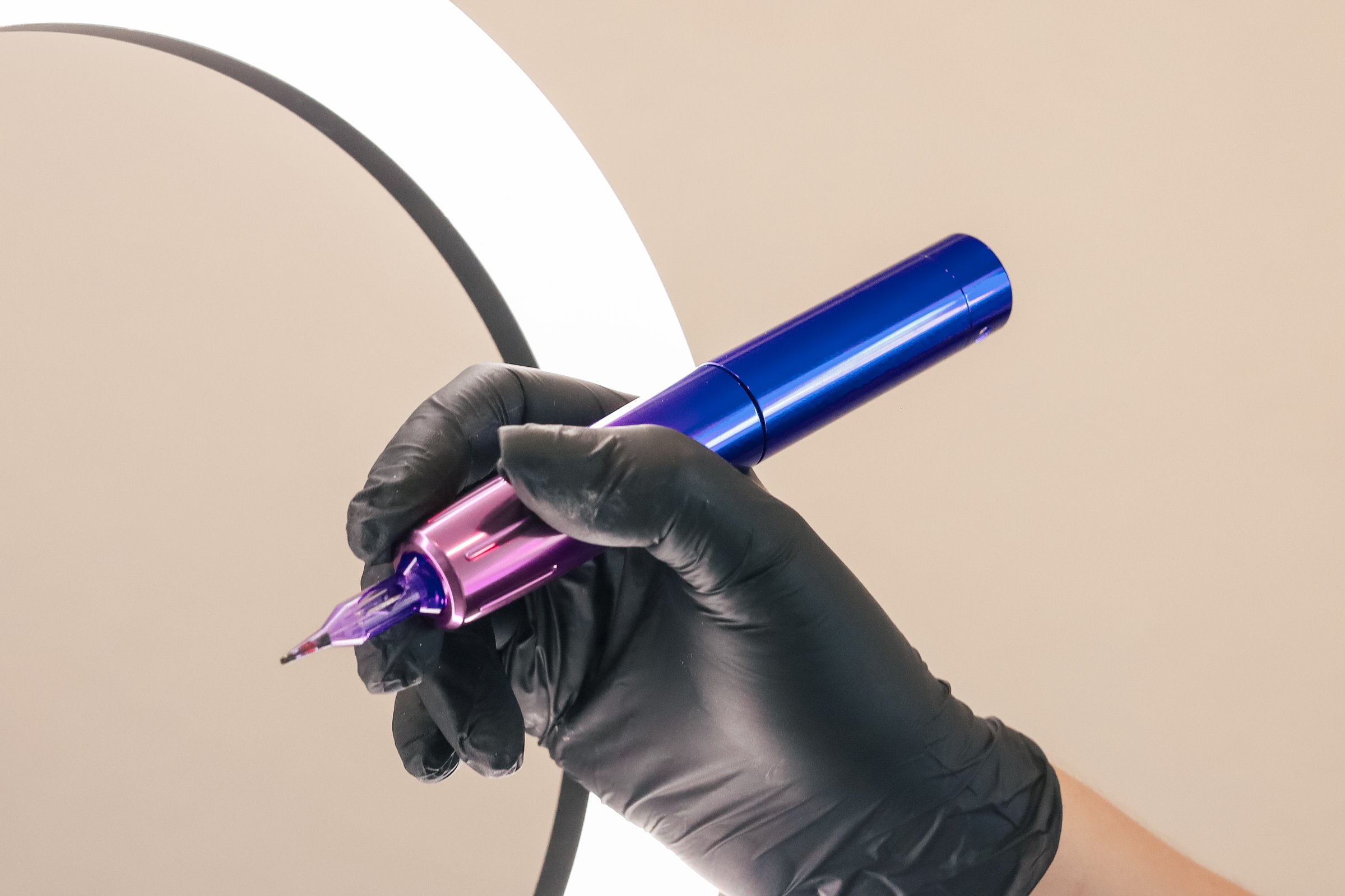 Eyebrow correction procedure tools. Machine for permanent makeup in female hand. Brows tattooing. Microblading brow and lips