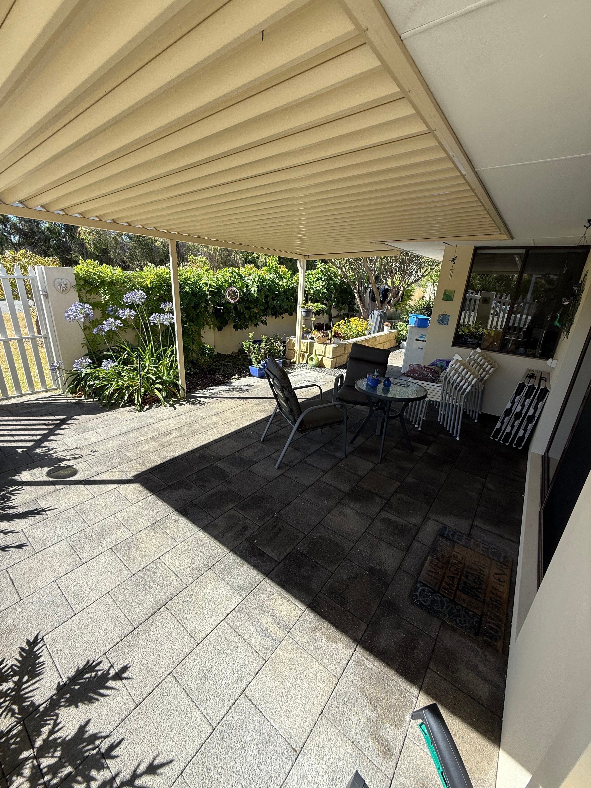 Professional patio cleaning service showing before and after results