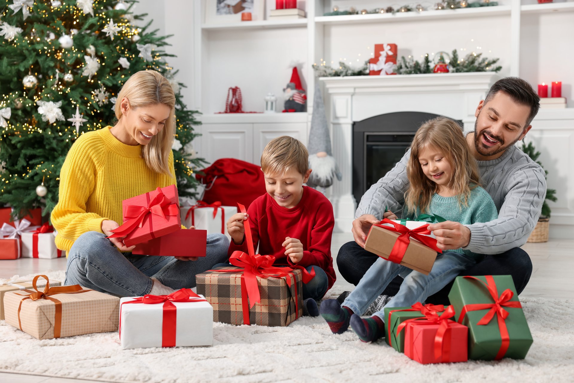 Happy family with Christmas gifts at home