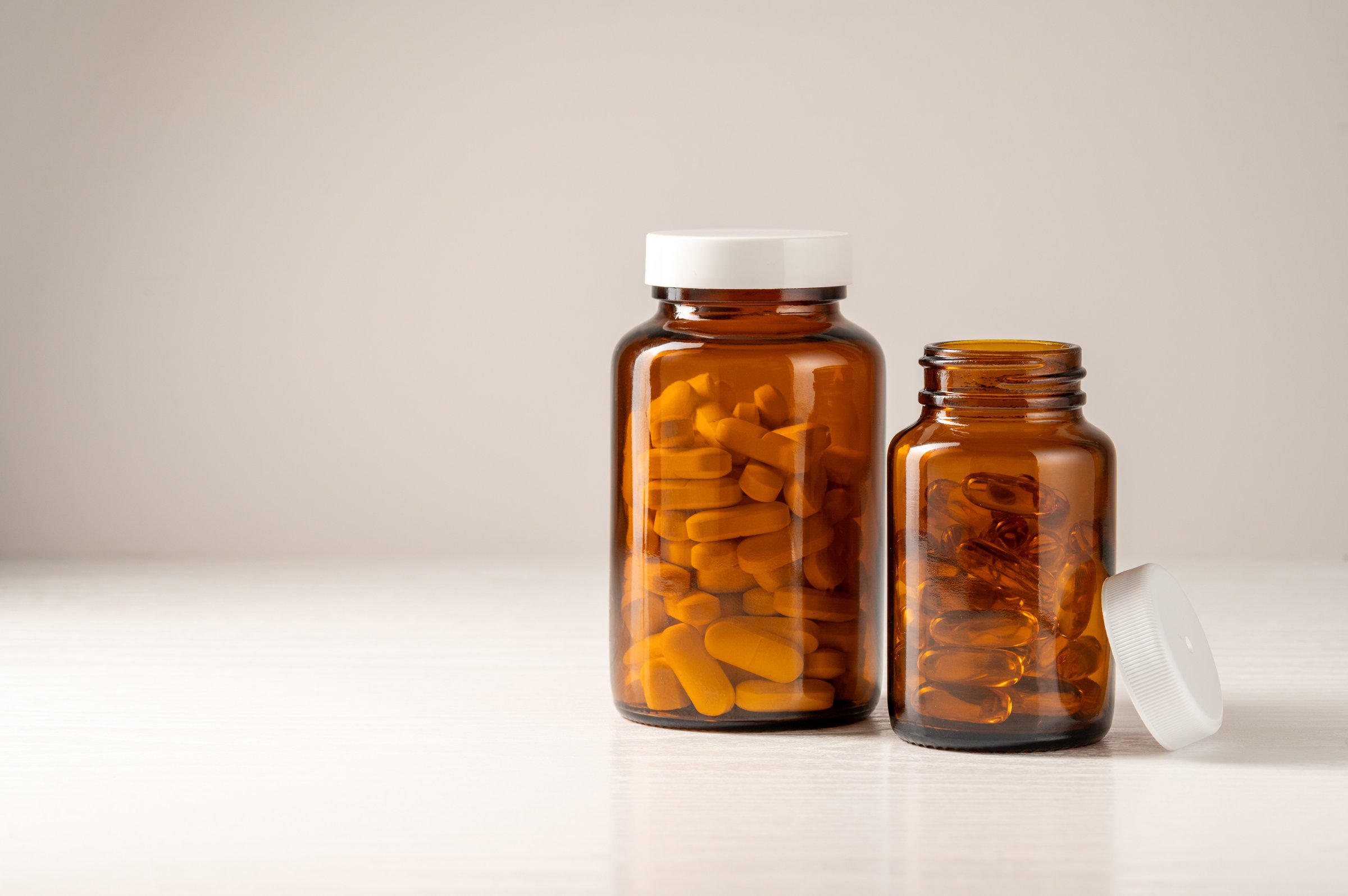 Vitamins, pills, omega 3, food supplements in  glass jar, health and wellness. Food supplement.