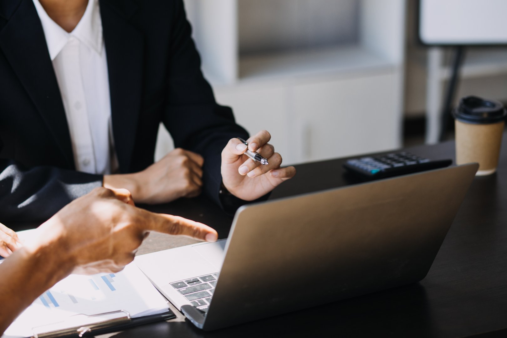 Asian Business woman using calculator and laptop for doing math finance on an office desk, tax, report, accounting, statistics, and analytical research concept