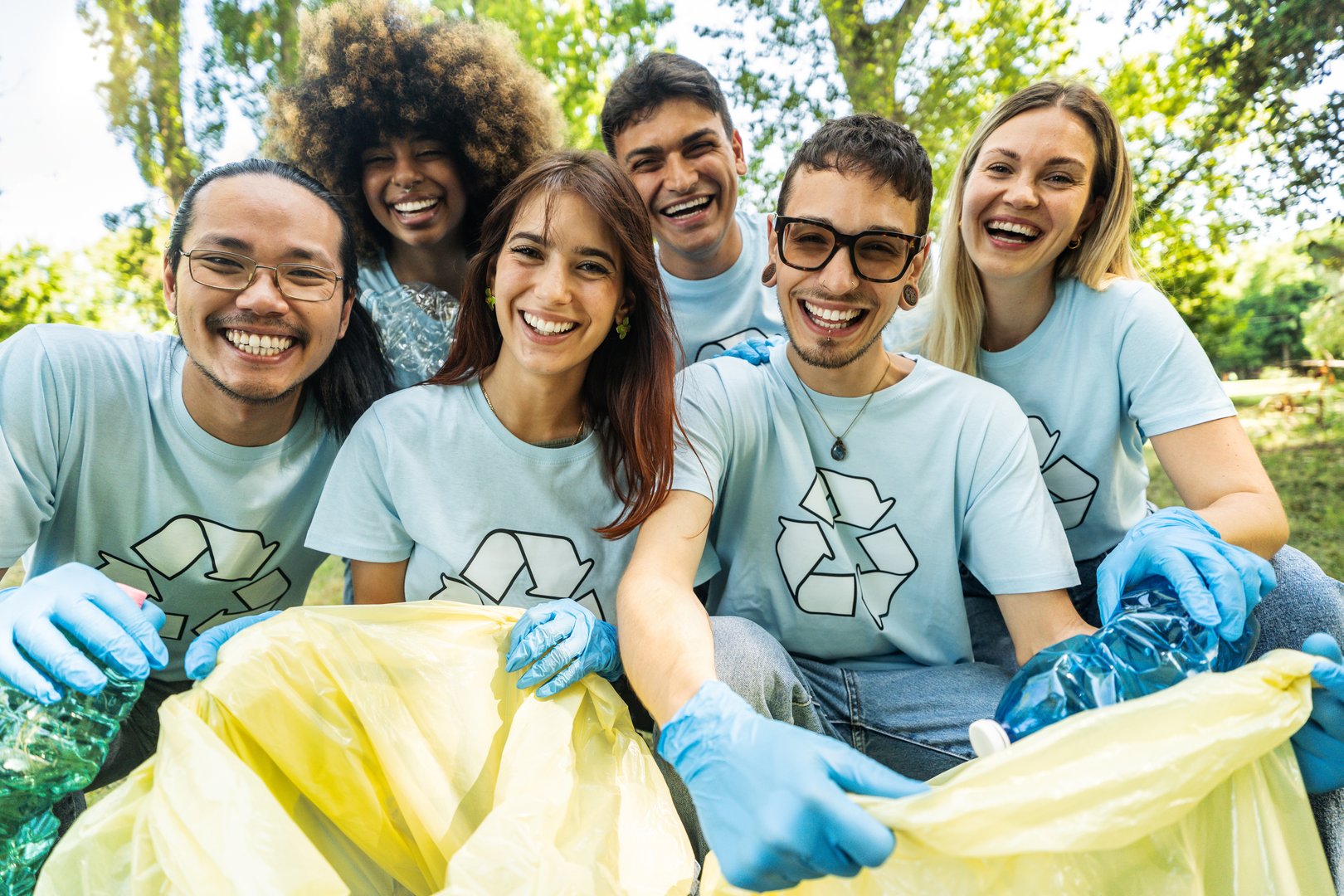 Group of volunteer cleaning picking up plastic litter in the park - Diverse group of people collect trash in the forest - Environmental protection, non profits organization and save the planet concept