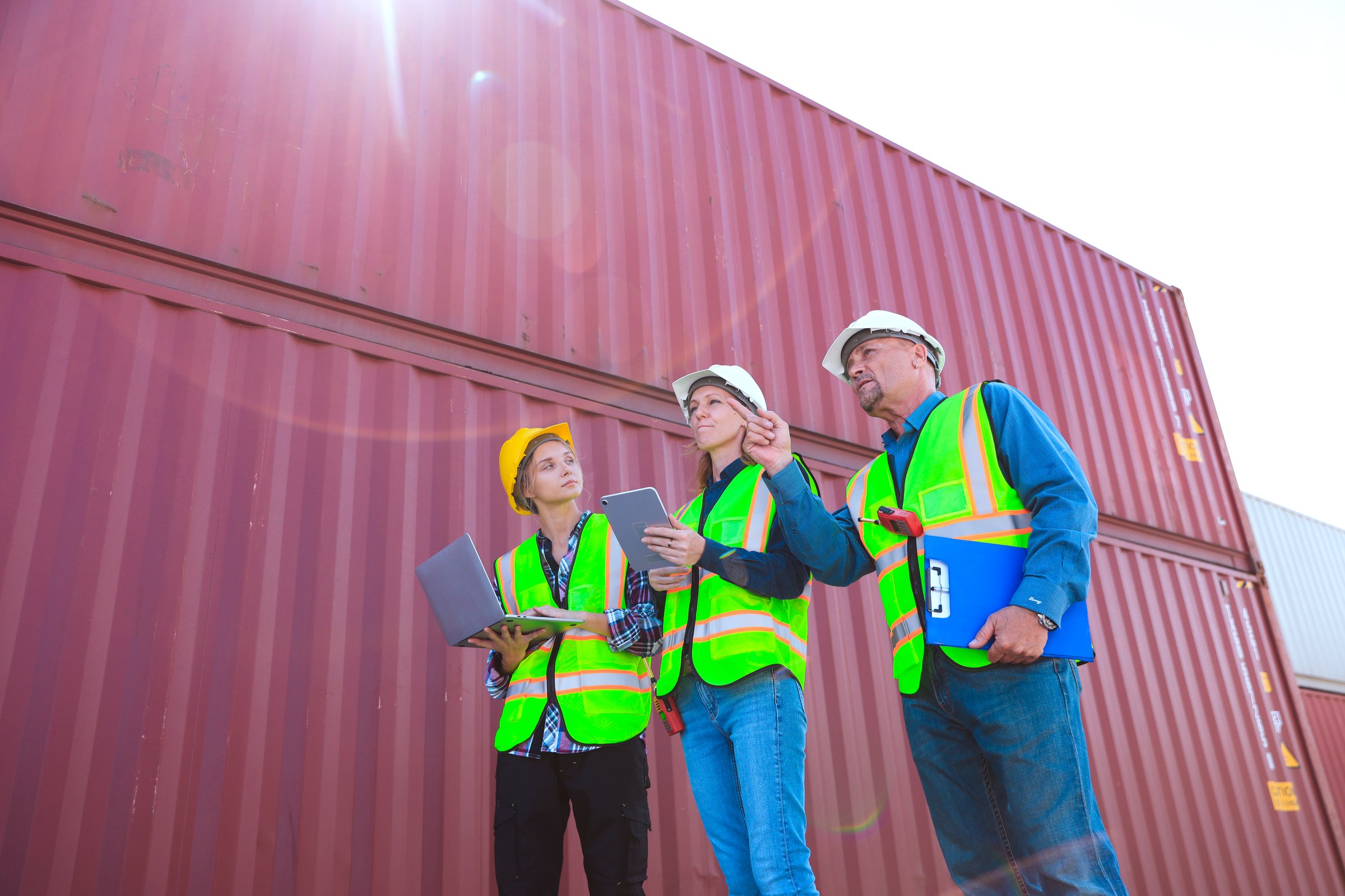 Business professionals efficiently transporting containers, dedicated blue-collar workers managing container warehouses, and diligent dock workers collaborating in the shipping yard.