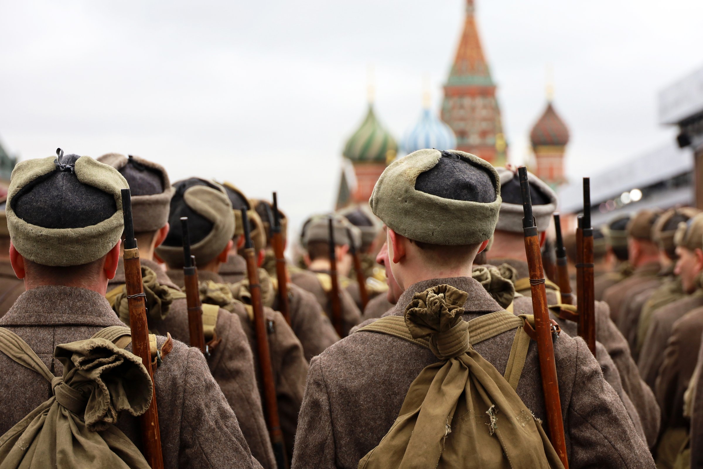 Moscow, Russia - November 7, 2024: Russian soldiers in Soviet military uniform of World War II marching on Red square on St Basil Cathedral background