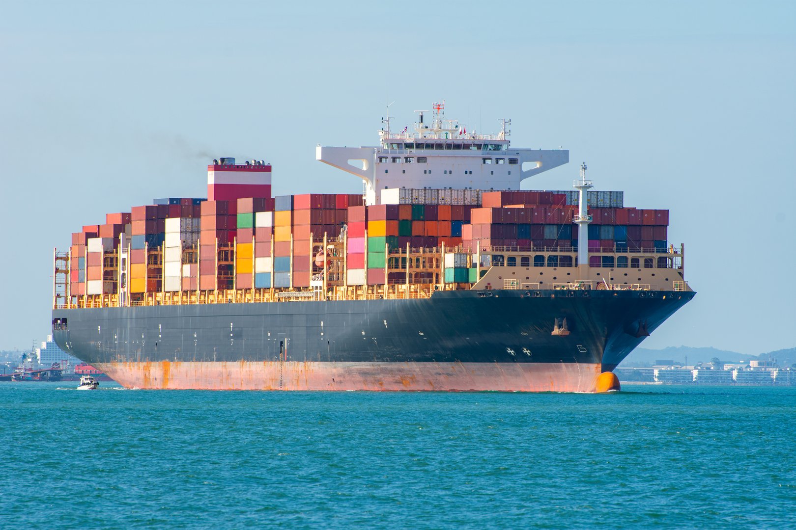 Top view Container ship full capacity approaching  port International Container ship loading, unloading at sea port, Freight Transportation, Shipping,  Vessel. Logistics, import export, Transportation. Global transport business.