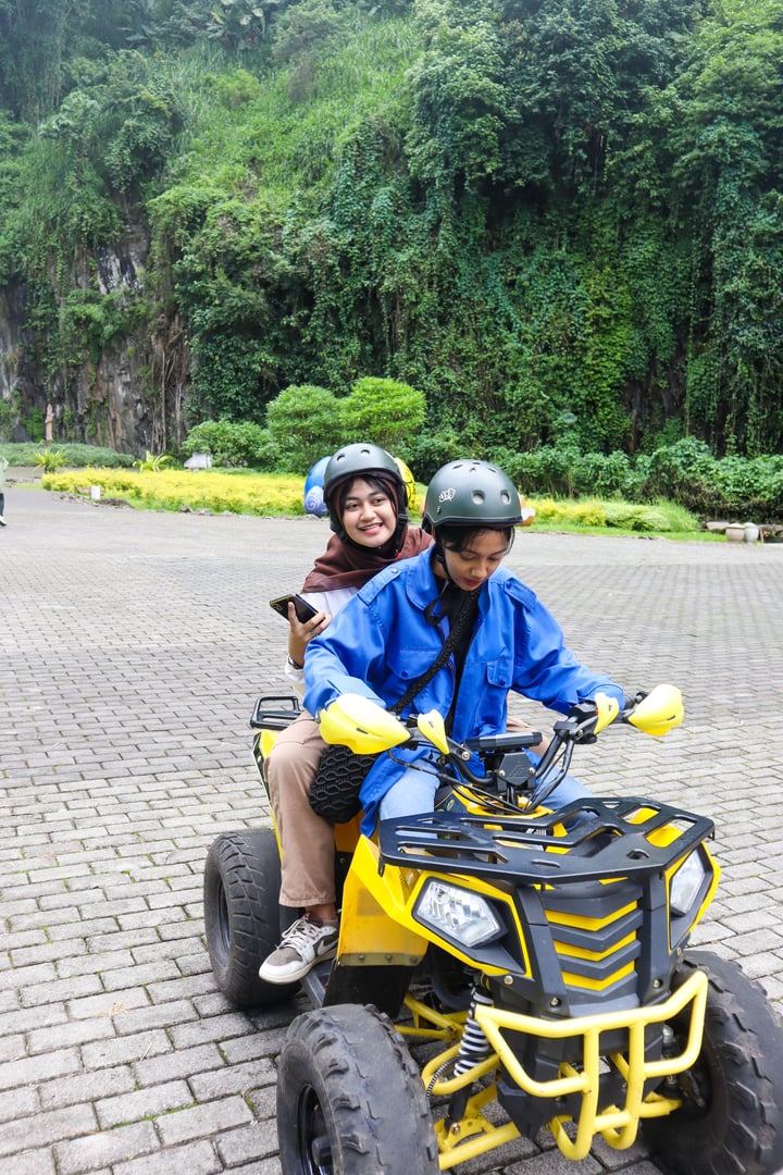 malang, indonesia - 10 april 2024: a visitor driving an atv in taman kemesraan