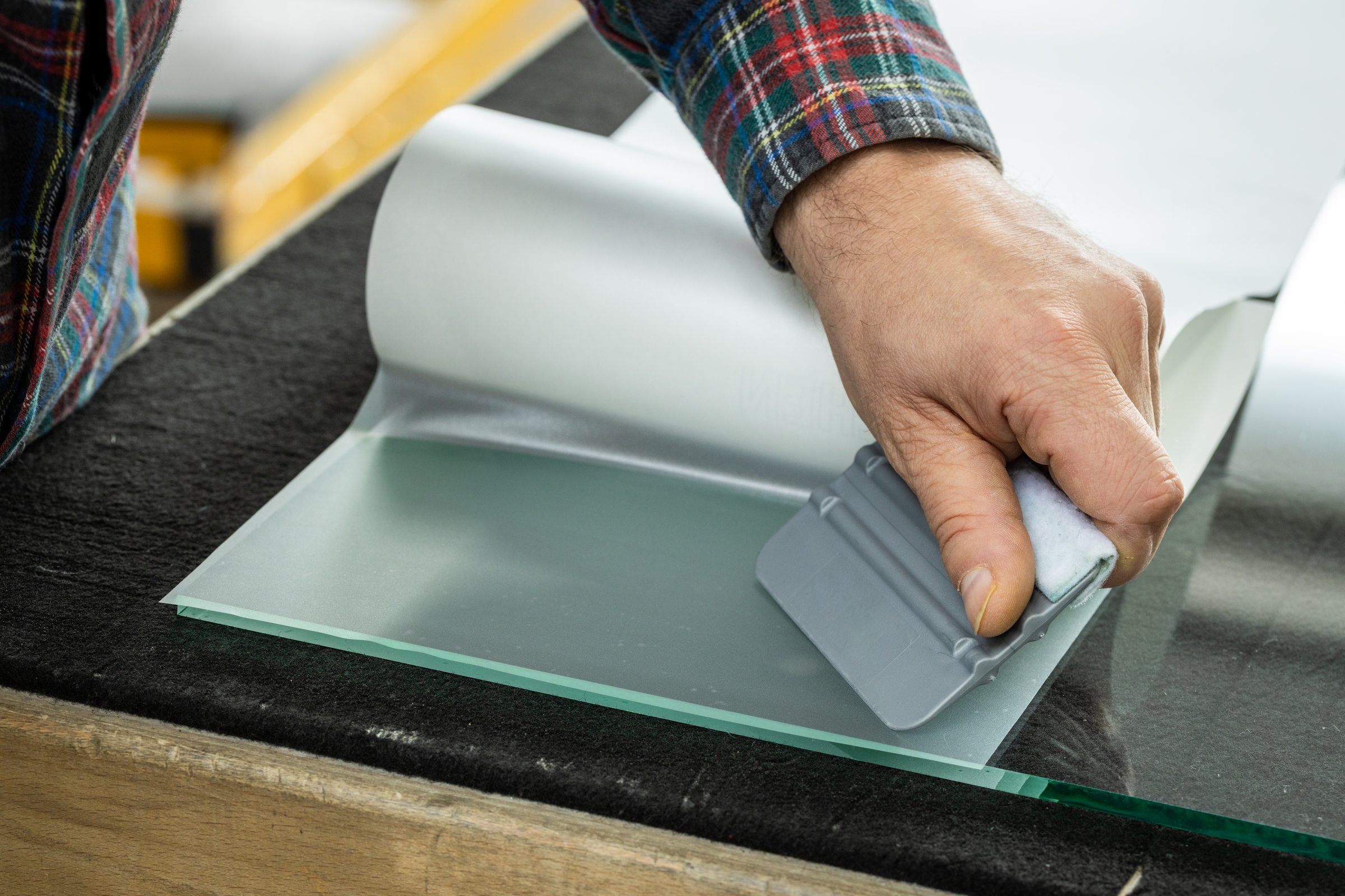 Gluing decorative foil on the glass, Work of a specialist