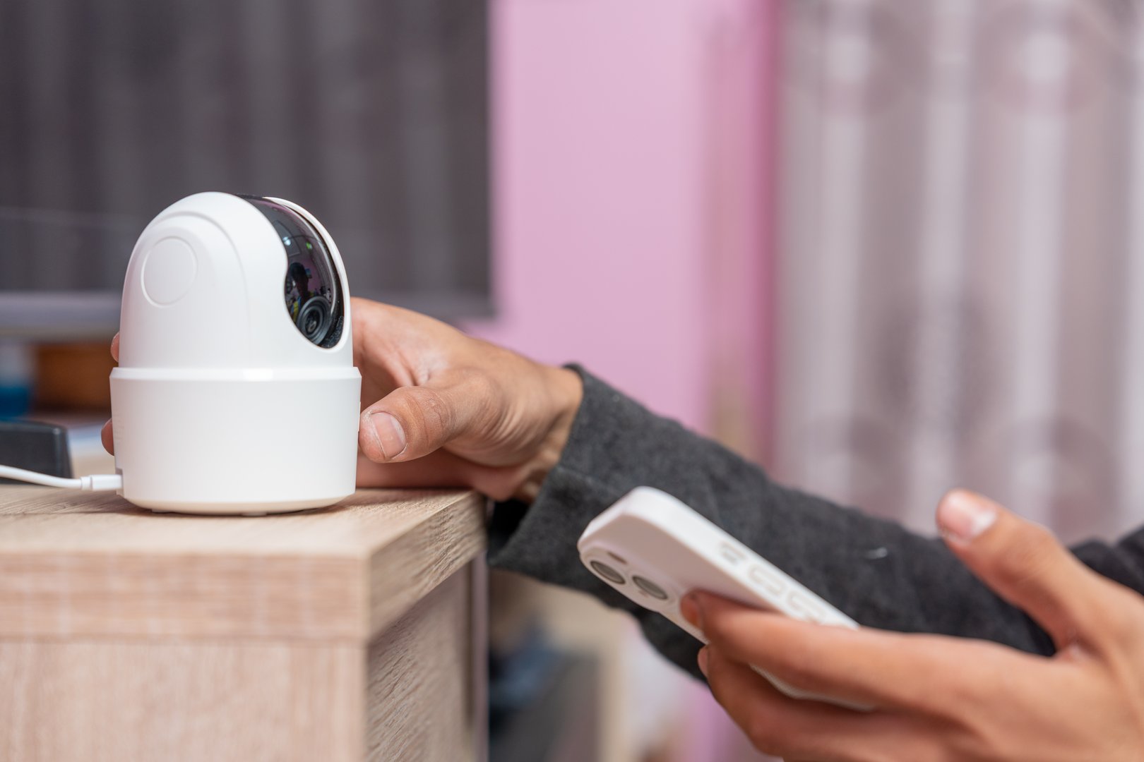 Close-up hand of man installs wireless security cameras