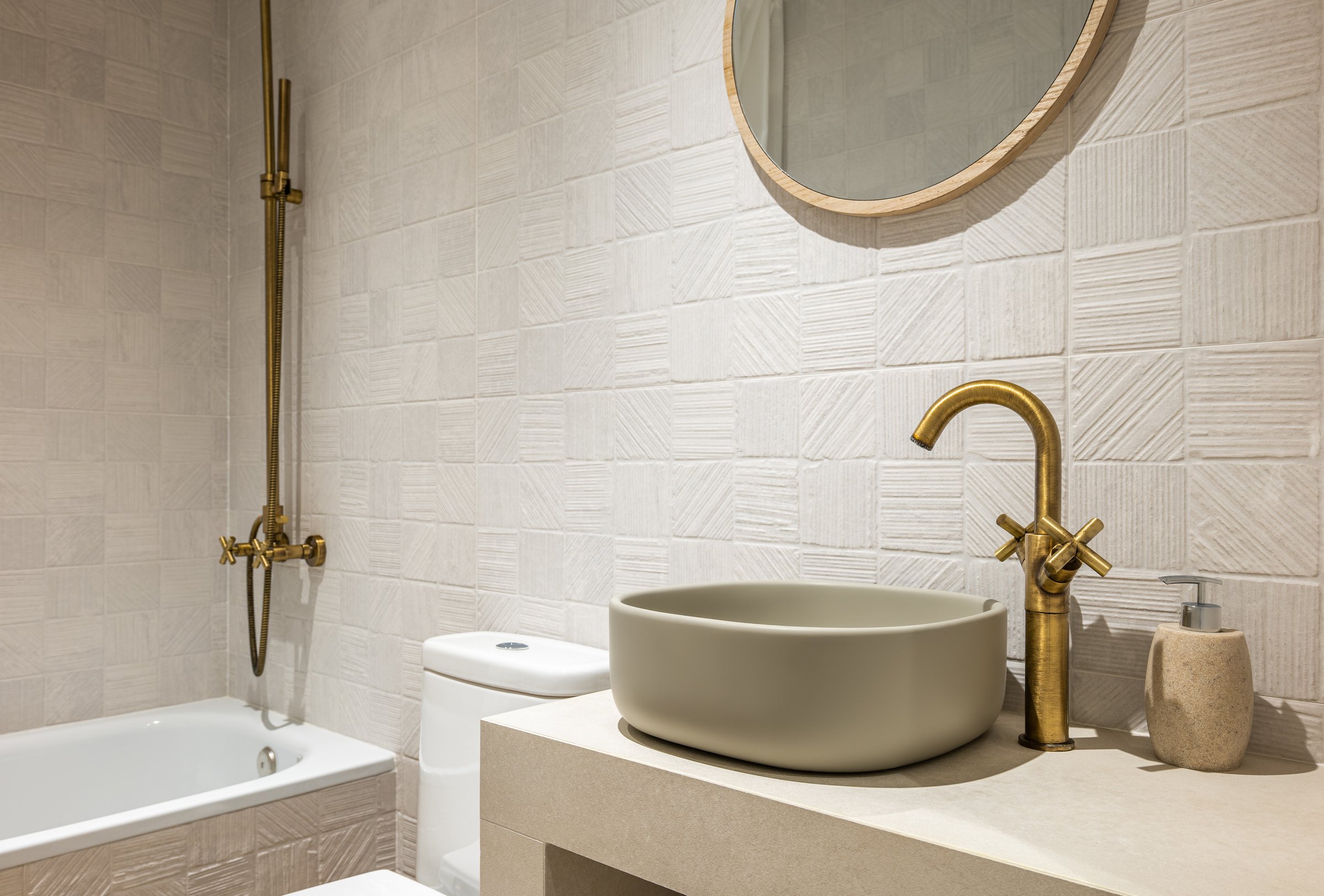 Bright bathroom in soothing pastel colors with textured ceramic tiles