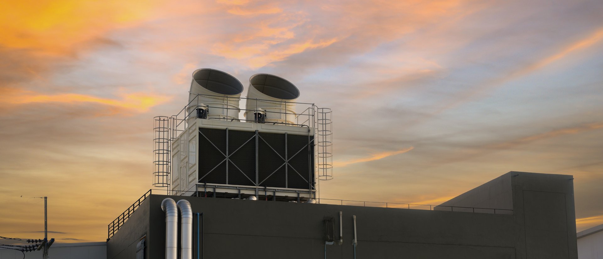 Exhaust vents of industrial air conditioning and ventilation units on roof top of large building