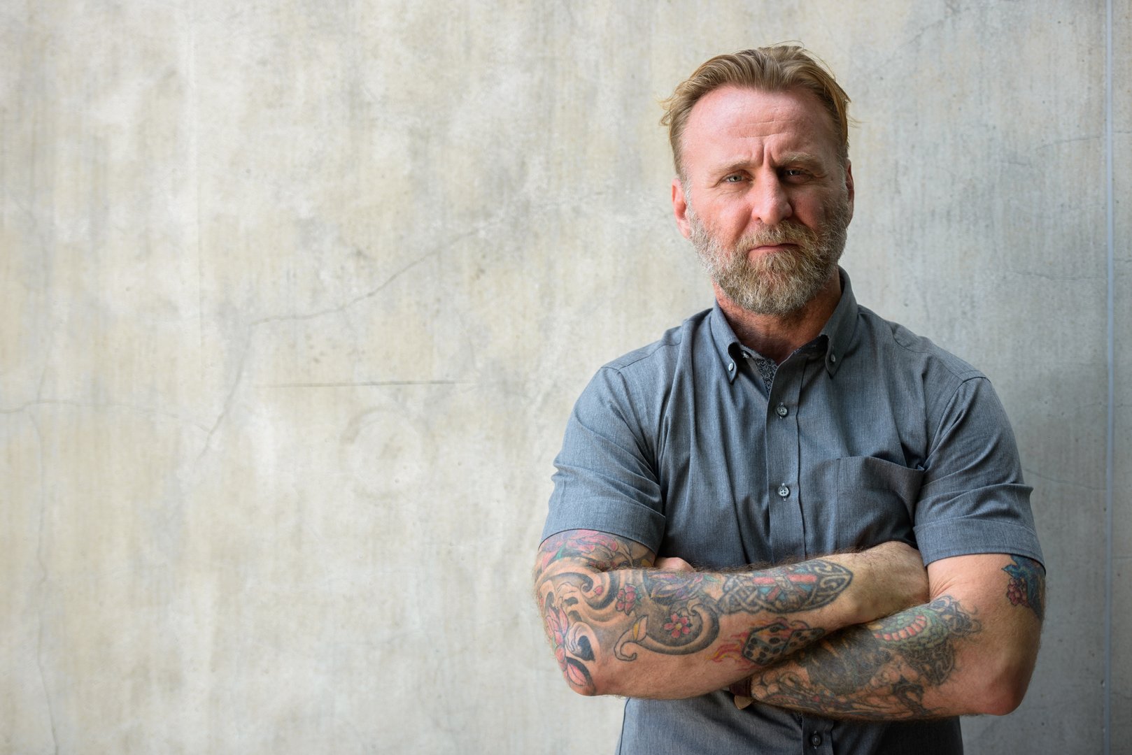 Portrait Of Man Standing Against Wall