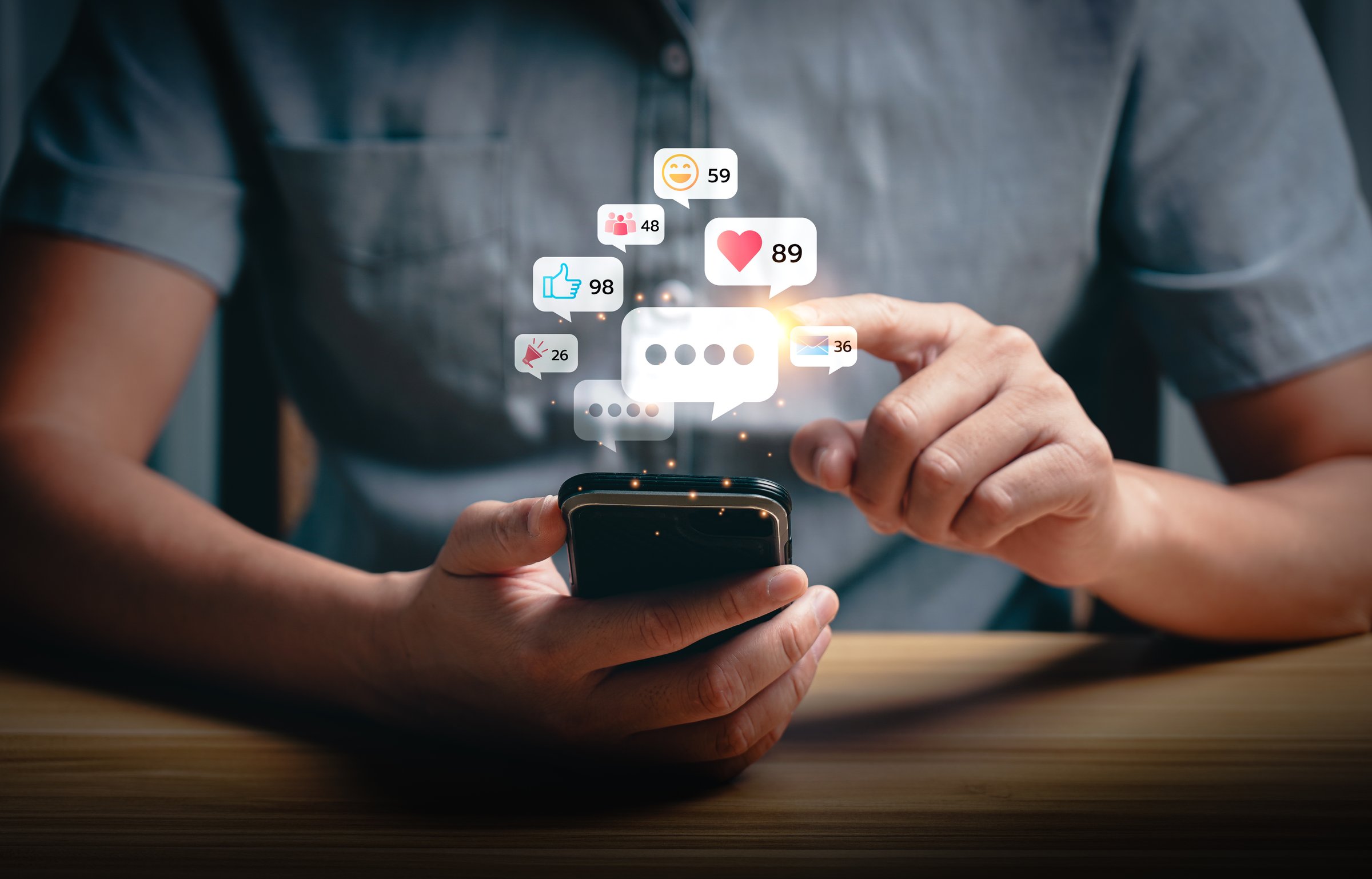 Social media interaction and online engagement concept with smartphone notifications. User touching screen to respond to likes, messages, and comments. Digital communication and network connection.