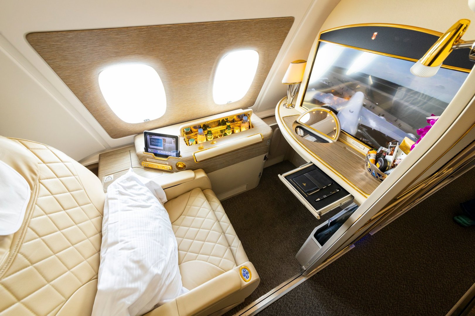 Berlin, Germany - June 7, 2024: Emirates Airlines First Class window seat in Airbus A380 upper deck. Luxurious travel style.