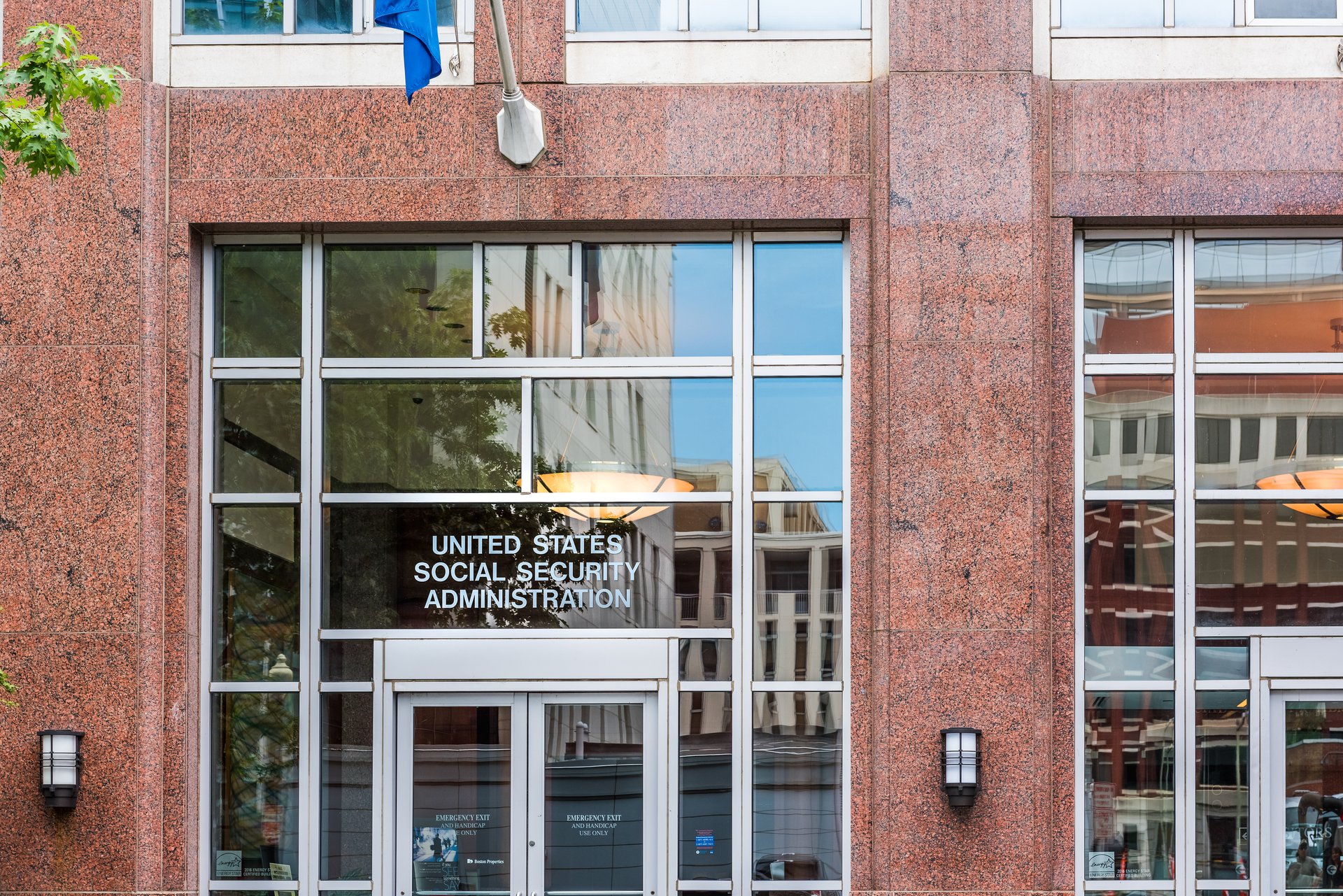 Washington Dc: United States Social Security Administration in downtown with flag, closeup of sign and building entrance