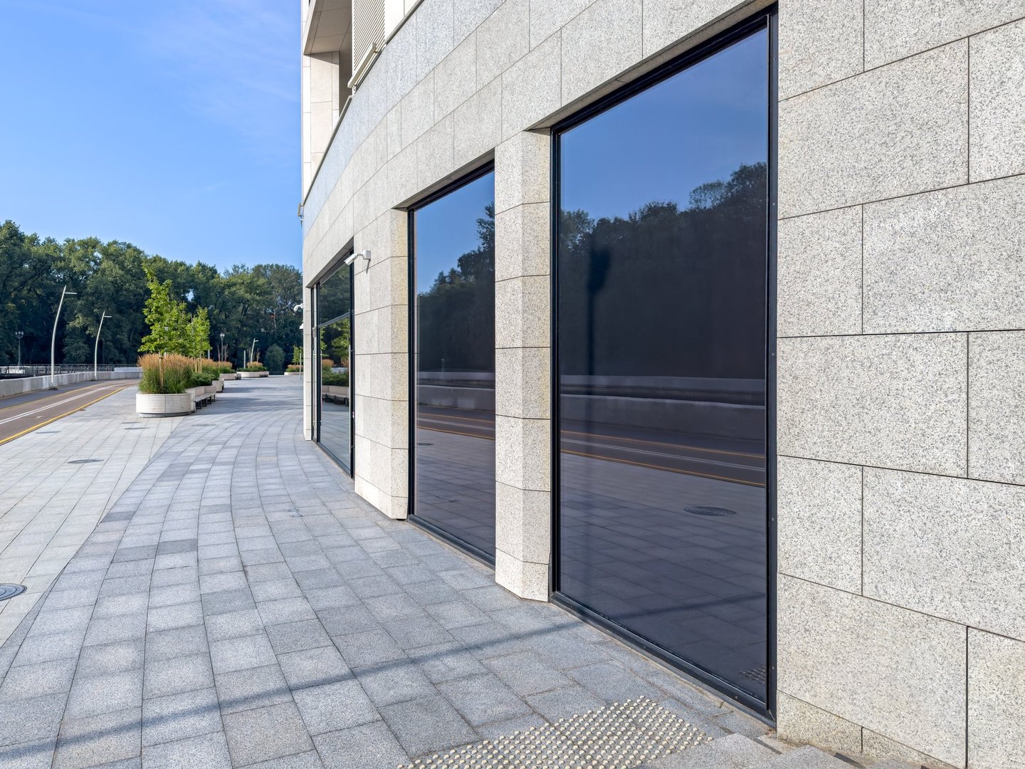 modern office building near city park in sunny day. urban corporate architecture.