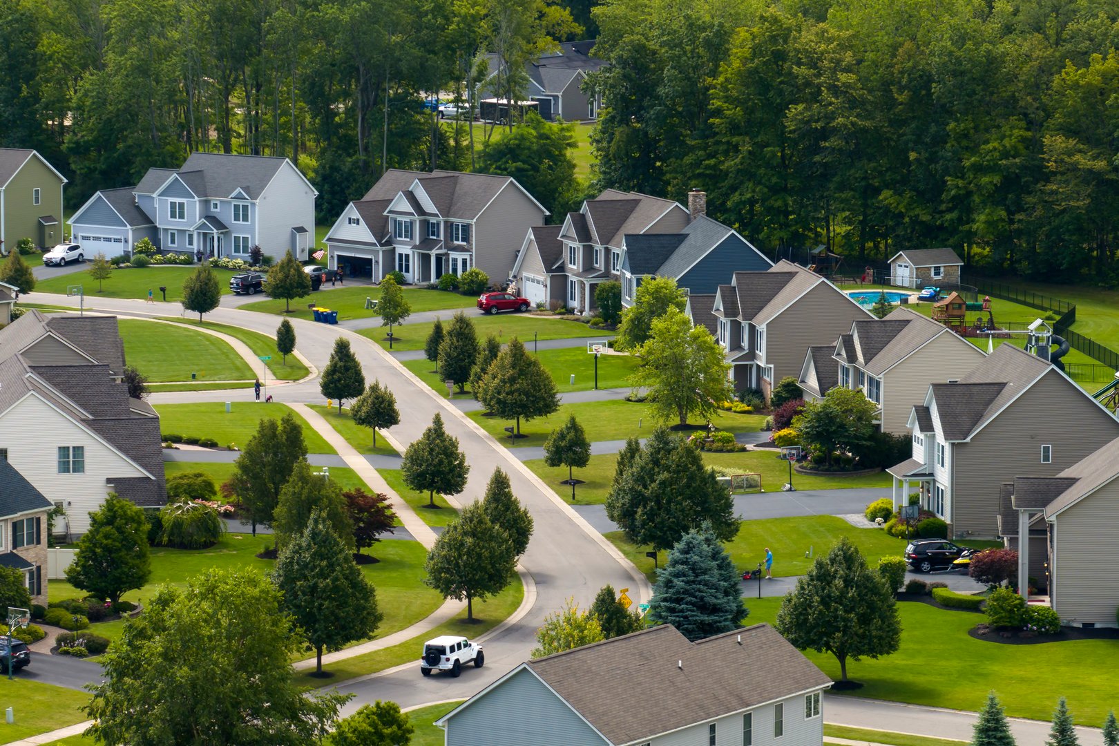 View from above of residential houses in living area in Rochester, NY. American dream homes as example of real estate development in US suburbs.