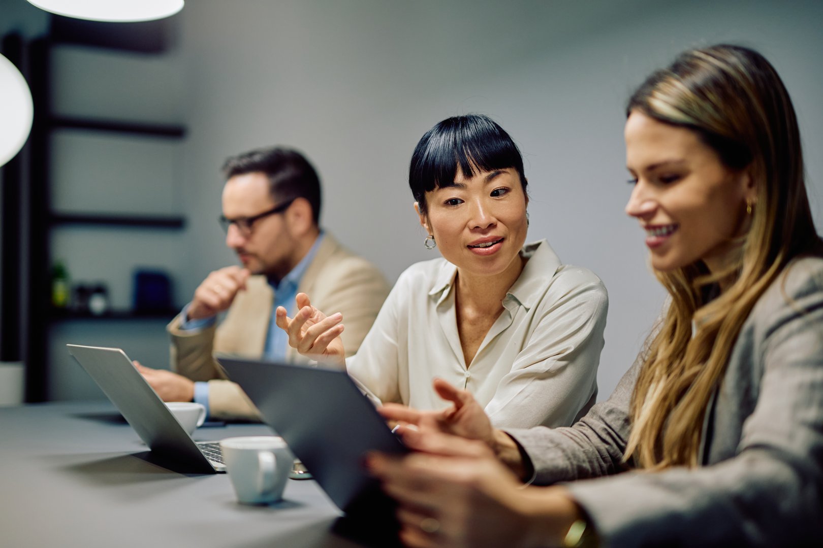 Diverse business team collaborating while discussing project strategy in a modern office environment