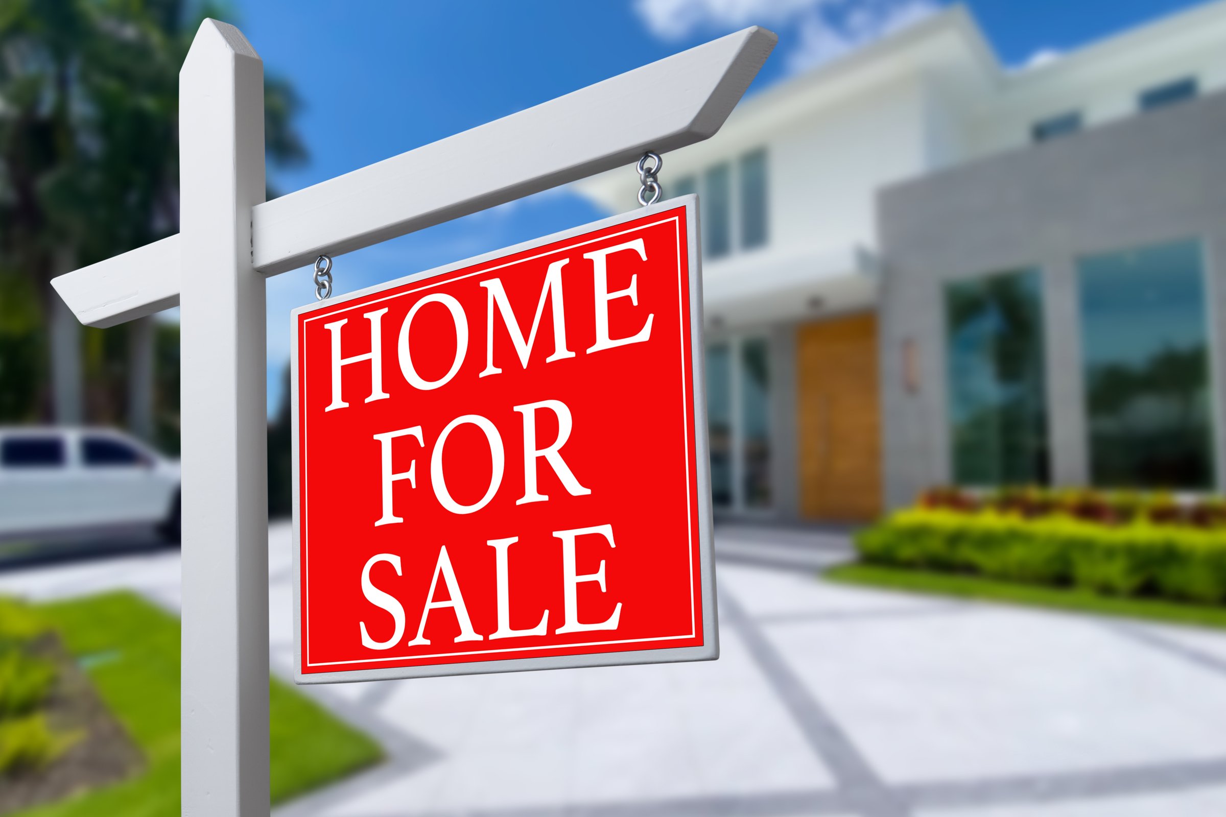 Home For Sale Real Estate Sign and Beautiful New House