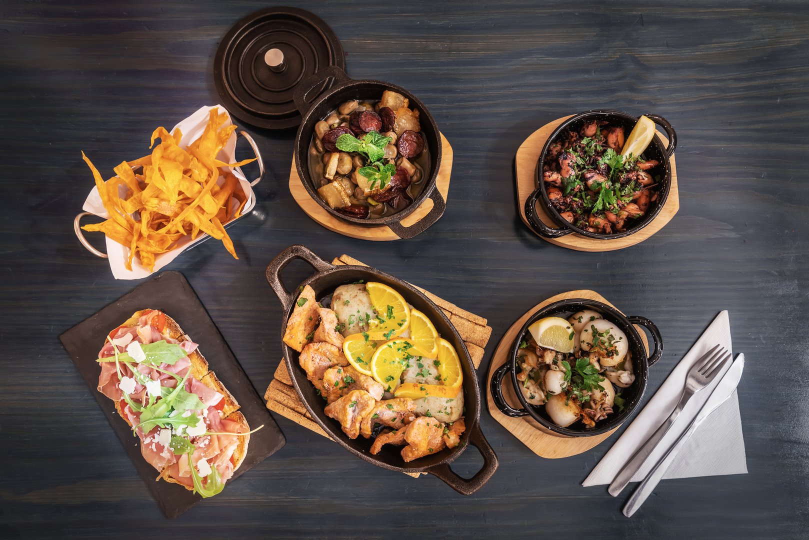 Traditional portuguese cuisine dishes of meat and fish products on a wooden table flat lay view. High quality photo