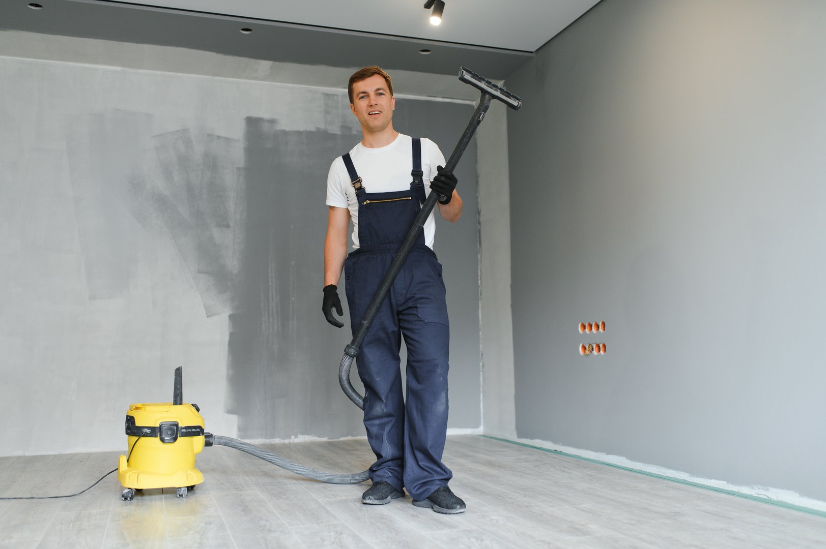 Worker vacuuming after renovation