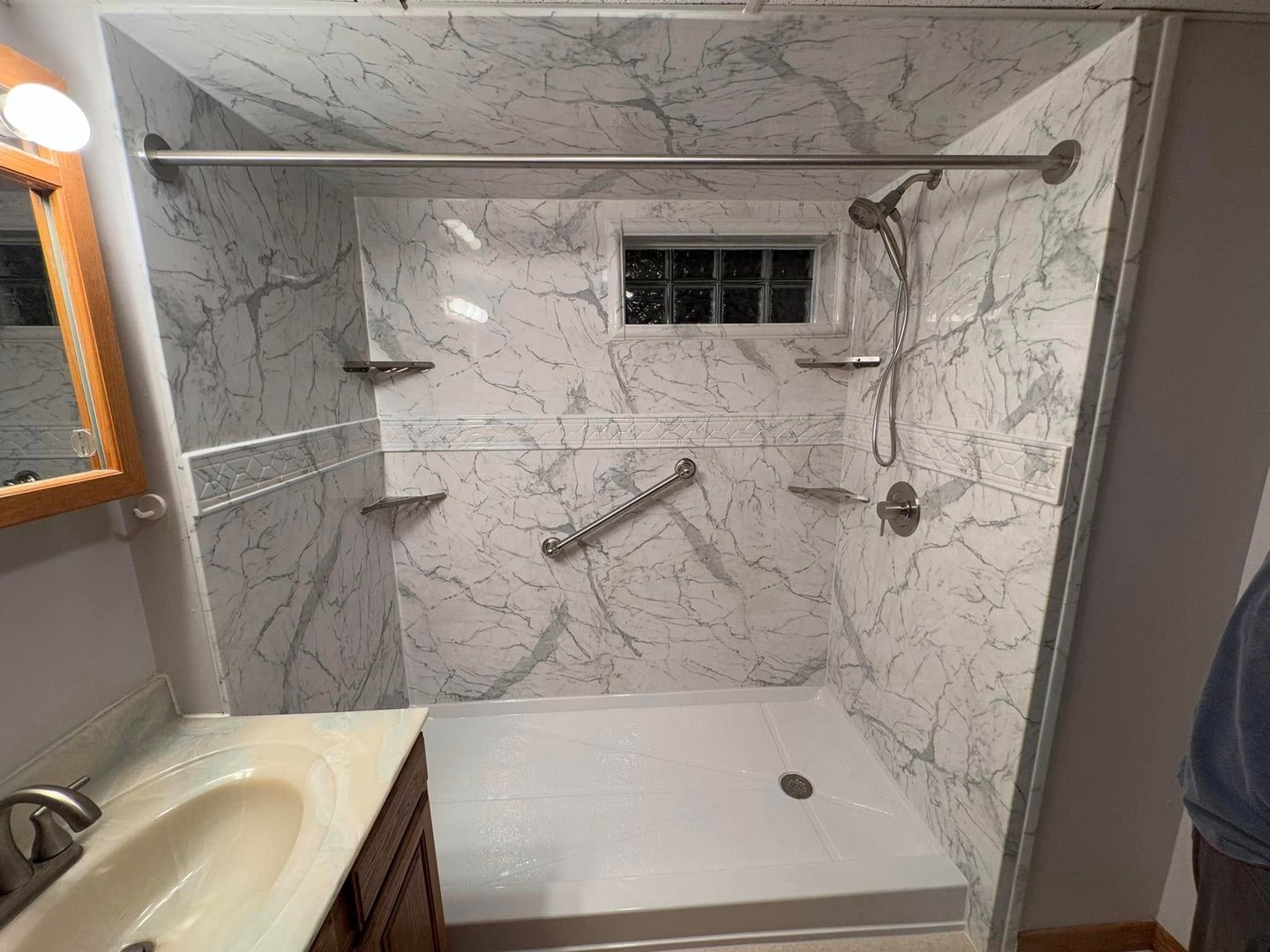 Completed bathroom remodel after mold repair in Toledo with modern walk-in shower