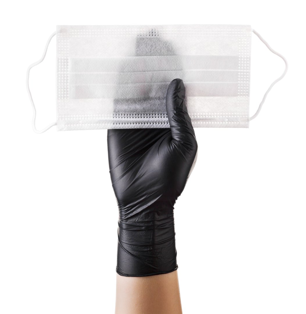 Hand in black gloves hold disposable face mask