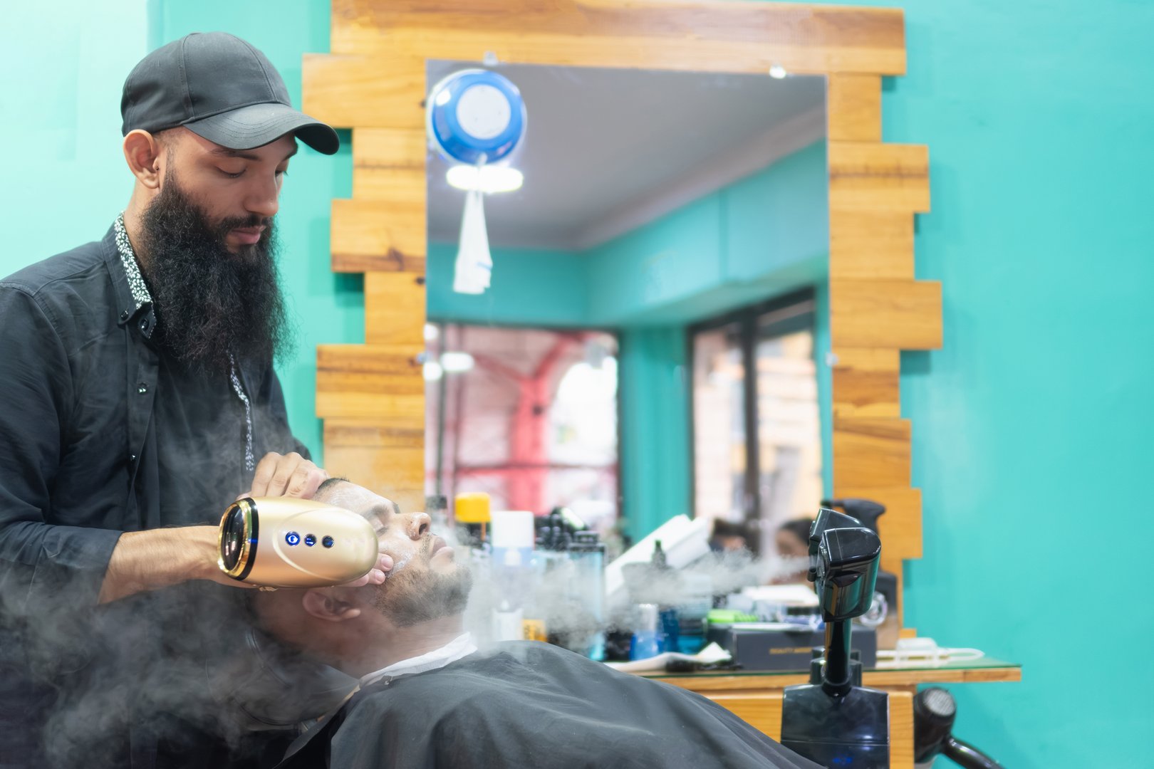 Barber steaming a customer's face before a shave in a beauty salon