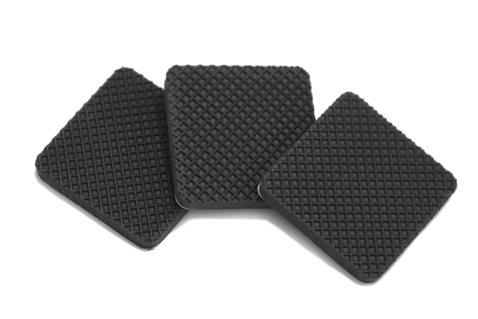 Three pieces of anti scratch and slip rubber over white background