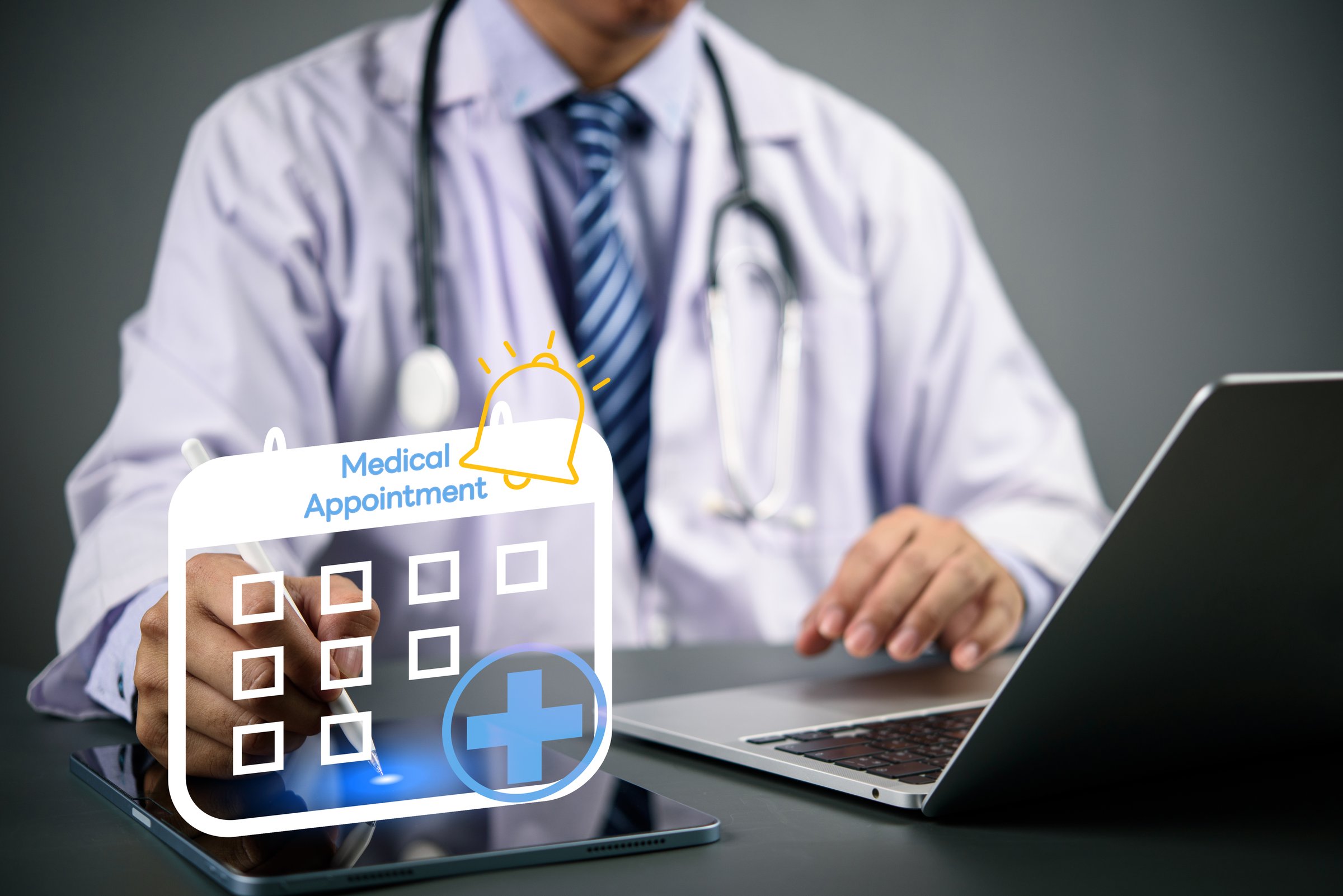 Doctor using digital tablet and laptop with medical appointment calendar icon, online booking system, e-health scheduling, and digital healthcare technology concept. doctor appointment