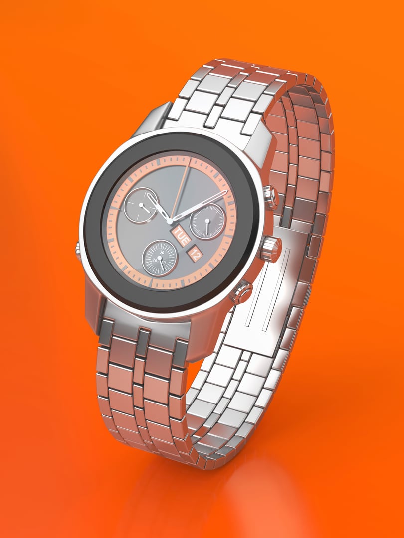 Silver chronograph watch on shiny orange background