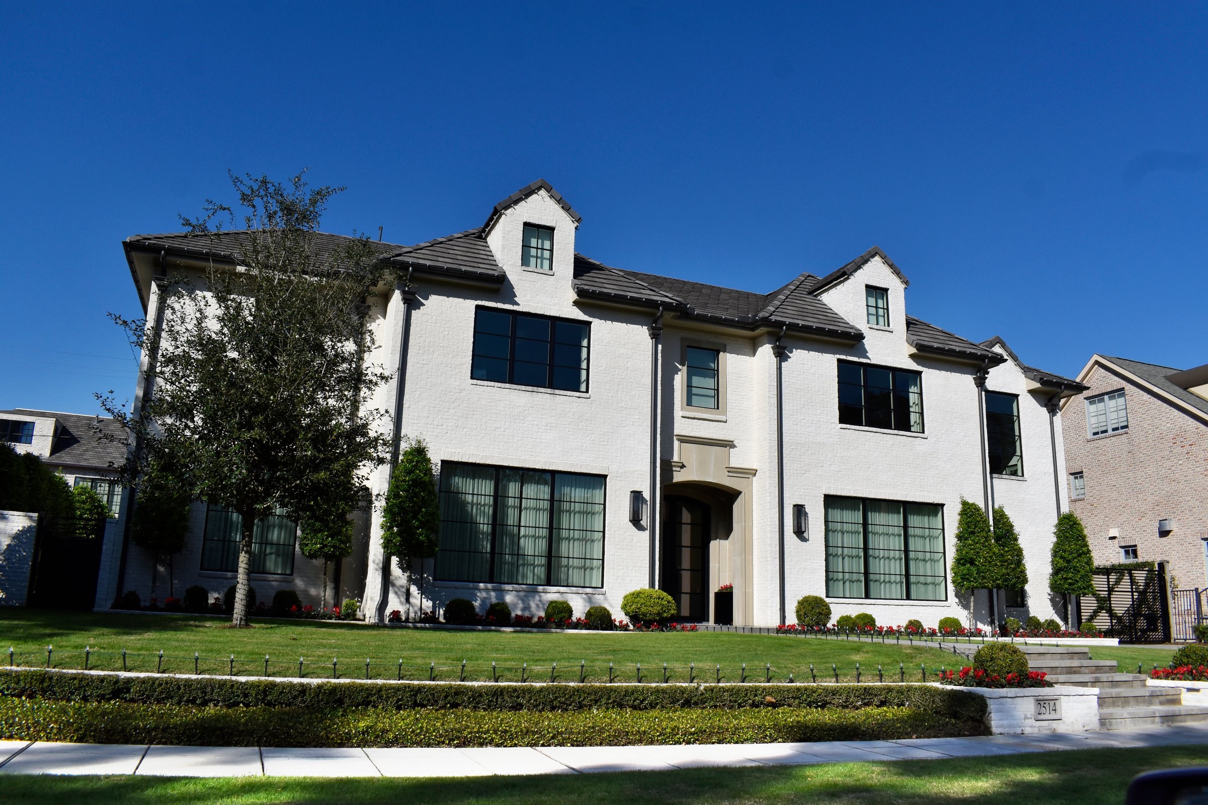 Houston, TX USA December 8, 2025 - A luxurious retro-styled mansion in a prestigious neighborhood, featuring elegant architecture, manicured landscaping, and timeless upscale design.